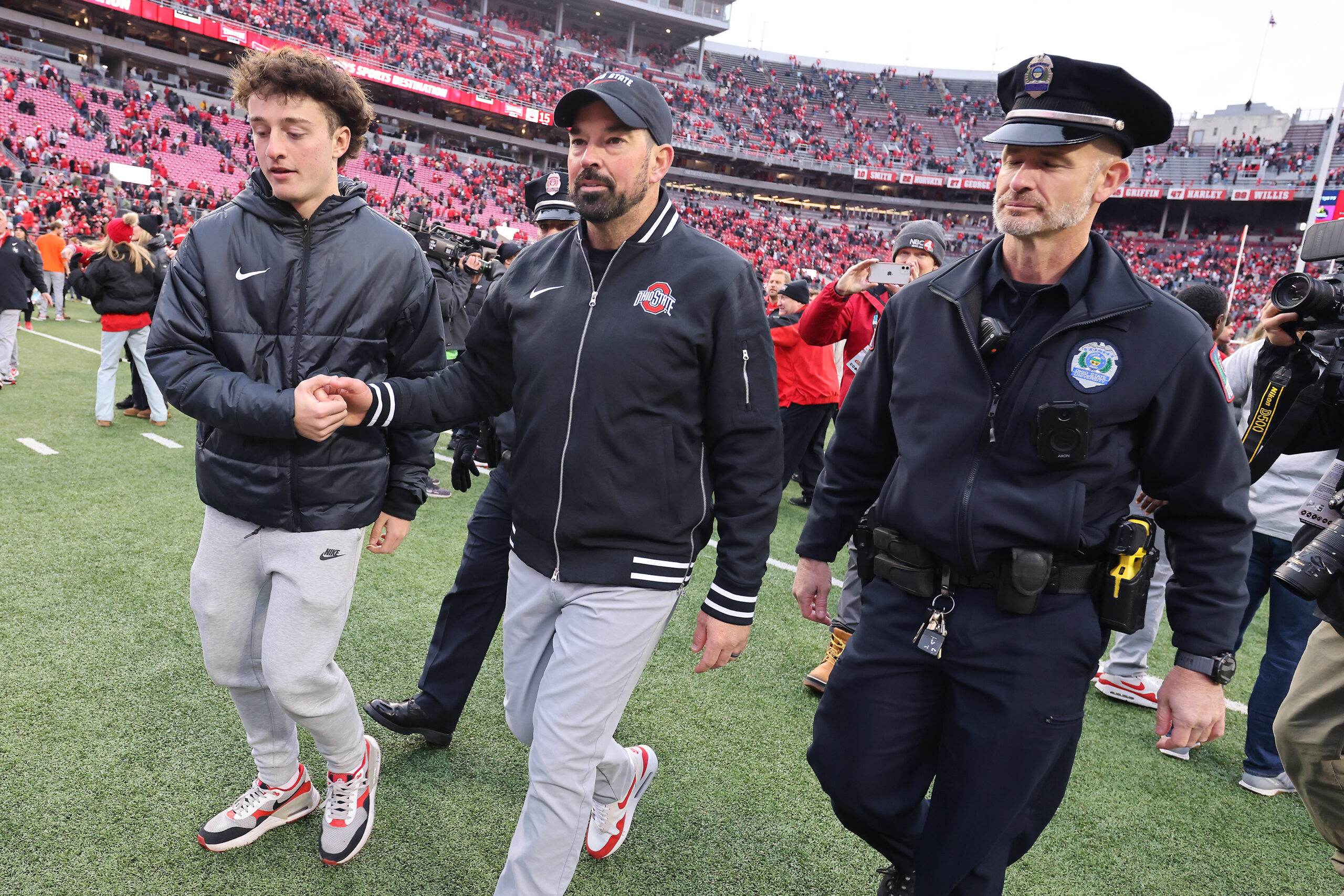 Nov 23, 2024; Columbus, Ohio, USA; Ohio State Buckeyes head coach Ryan Day celebrates with his son RJ Day (left) following the win against the Indiana Hoosiers at Ohio Stadium