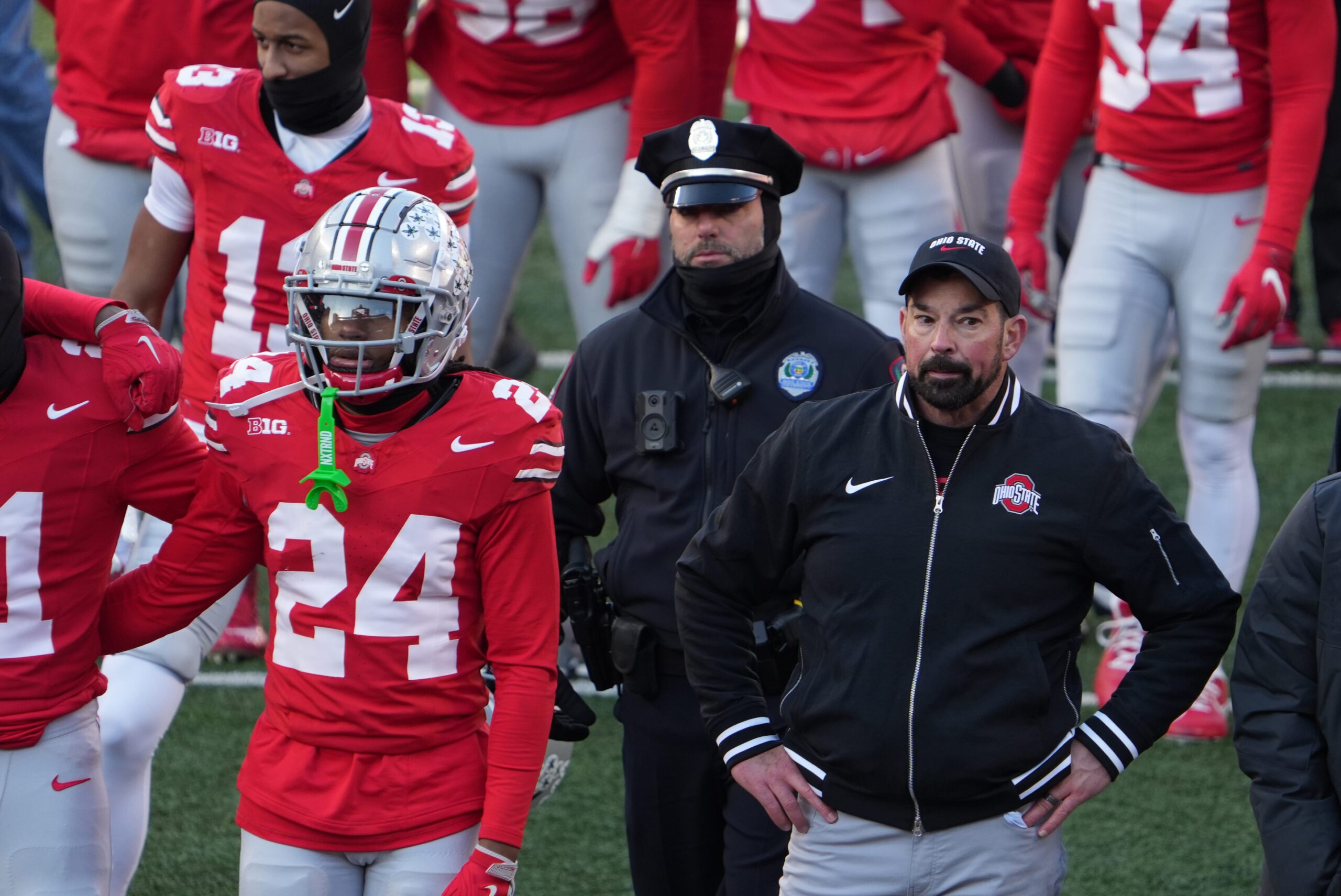 Ohio State University football coach Ryan Day tries to join the team to sing Carmen Ohio after the Michigan game Saturday, November 30, 2024 in Ohio Stadium. As he was standing here, the melee was starting behind him as Michigan players tried to plant a flag at midfield.