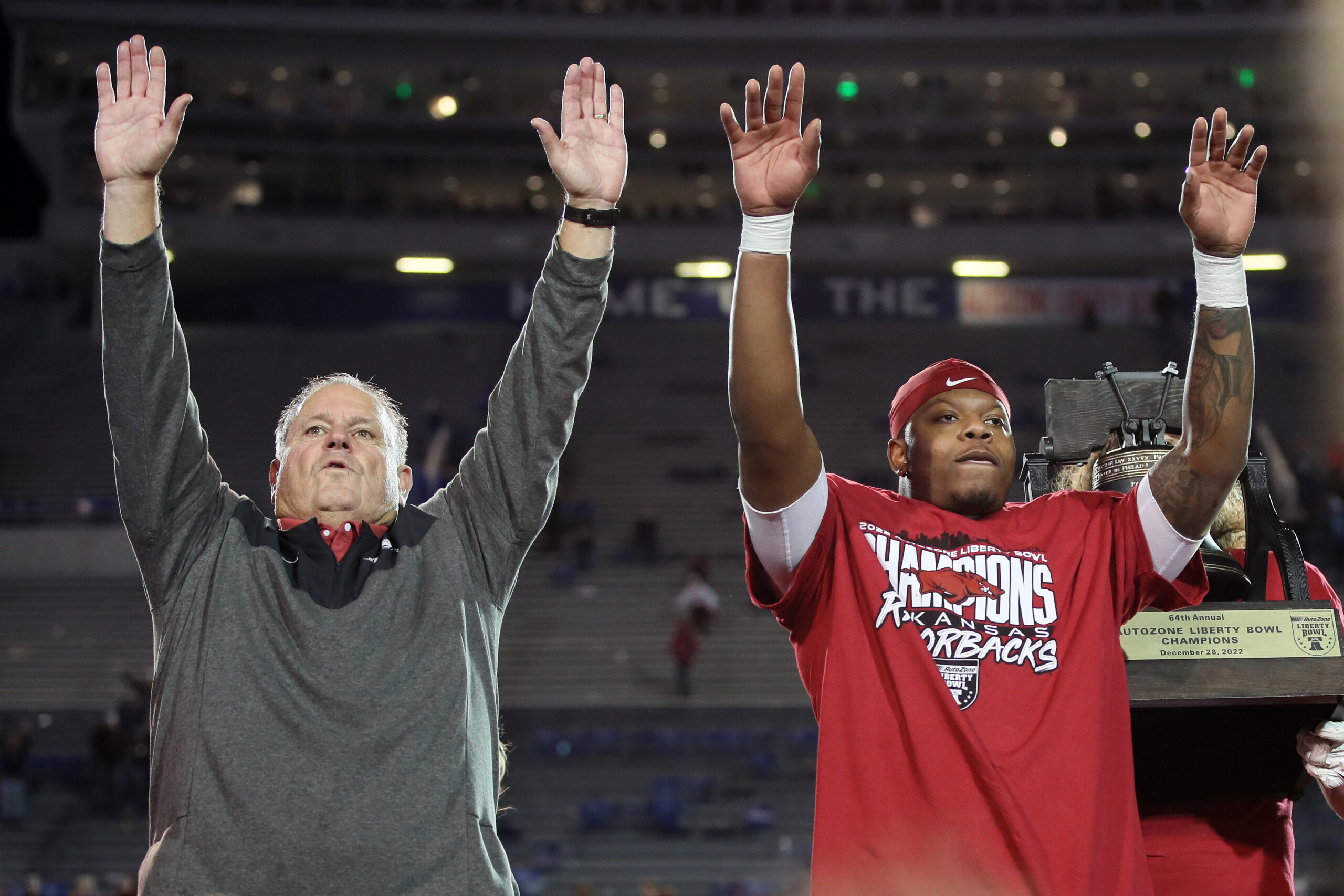 Dec 28, 2022; Memphis, TN, USA; Arkansas Razorbacks head coach Sam Pittman and quarterback KJ Jefferson call the hogs after defeating the Kansas Jayhawks in the 2022 Liberty Bowl at Liberty Bowl Memorial Stadium. Arkansas won 55-53.