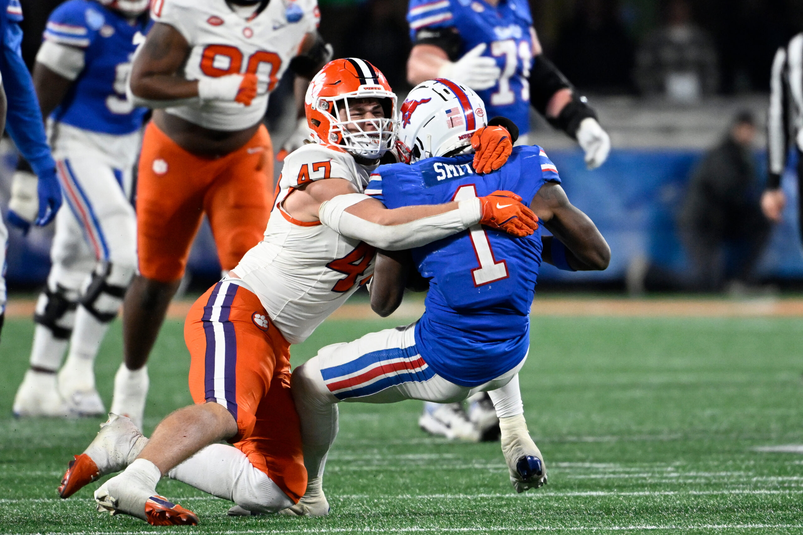 Dec 7, 2024; Charlotte, NC, USA; Clemson Tigers linebacker Sammy Brown (47) tackles Southern Methodist Mustangs running back Brashard Smith (1) in the fourth quarter in the 2024 ACC Championship game at Bank of America Stadium.