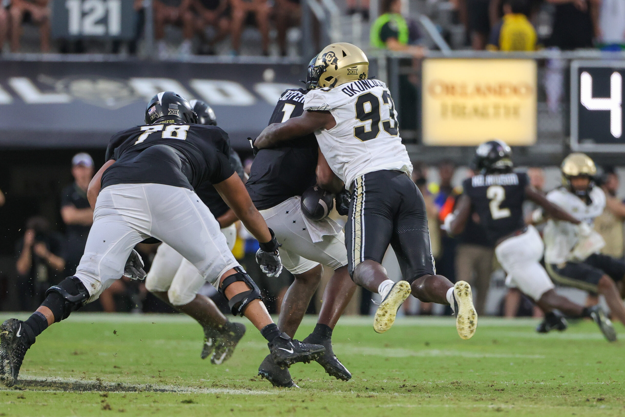 Sep 28, 2024; Orlando, Florida, USA; Colorado Buffaloes defensive end Samuel Okunlola (93) tackles UCF Knights quarterback KJ Jefferson (1) during the second half at FBC Mortgage Stadium.