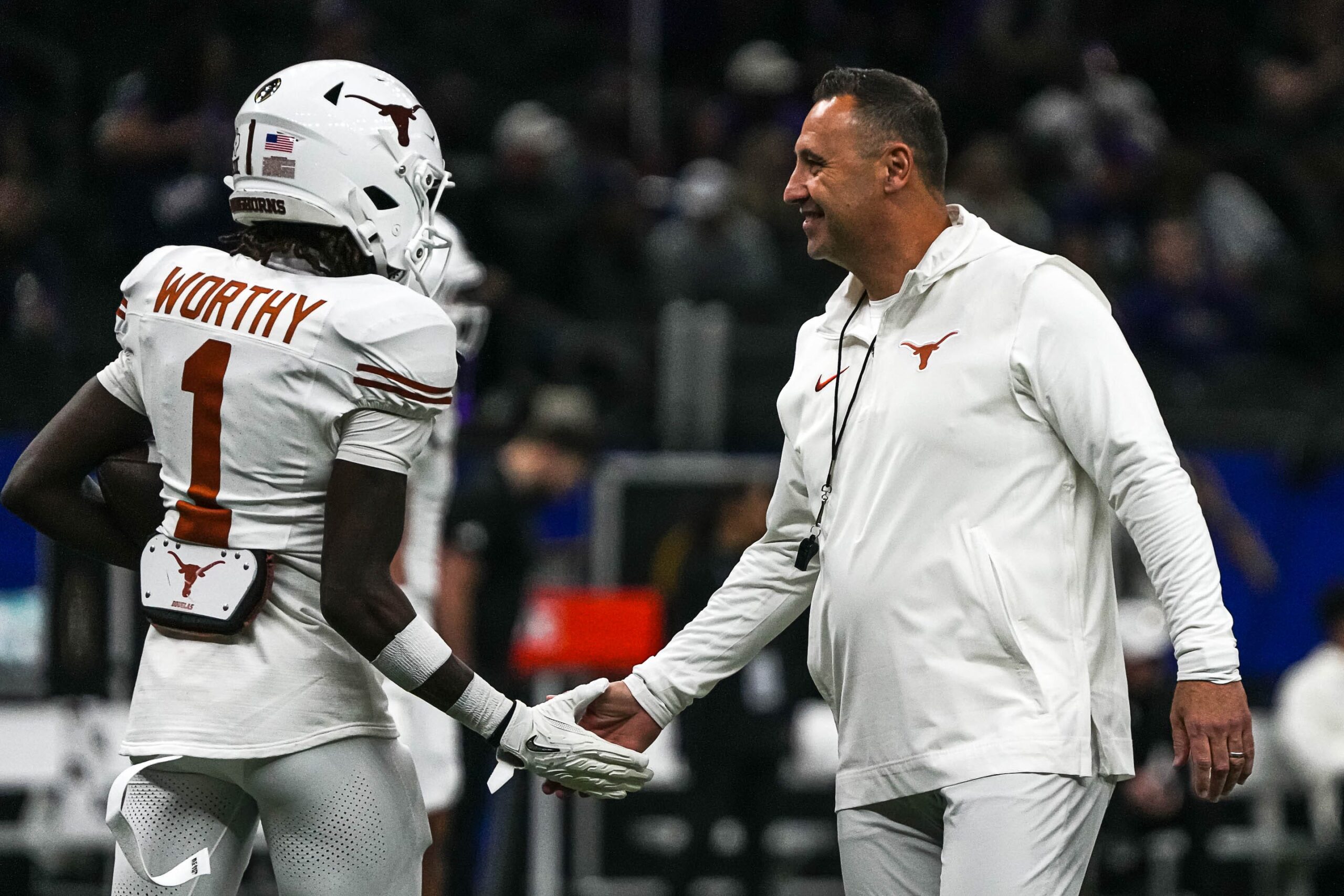 Texas Longhorns head coach Steve Sarkisian greets wide receiver Xavier Worthy (1) while warming up for the Sugar Bowl College Football Playoff semifinals game against the Washington Huskies at the Caesars Superdome on Monday, Jan. 1, 2024 in New Orleans, Louisiana.© Aaron E. Martinez/American-Statesman / USA TODAY NETWORK
