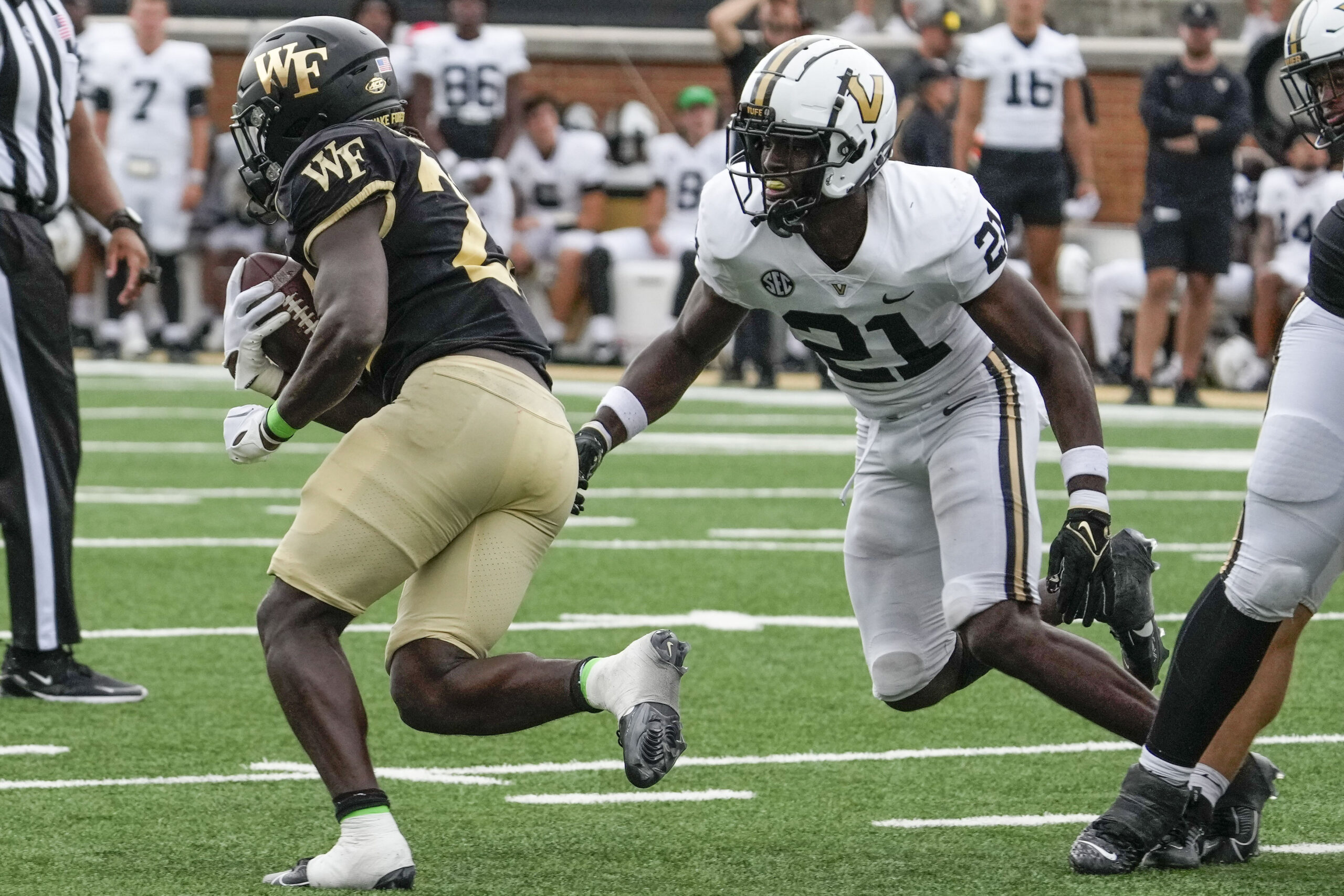 Sep 9, 2023; Winston-Salem, North Carolina, USA; Wake Forest Demon Deacons running back Demond Claiborne (23) runs past Vanderbilt Commodores safety Savion Riley (21) during the second half at Allegacy Federal Credit Union Stadium. 