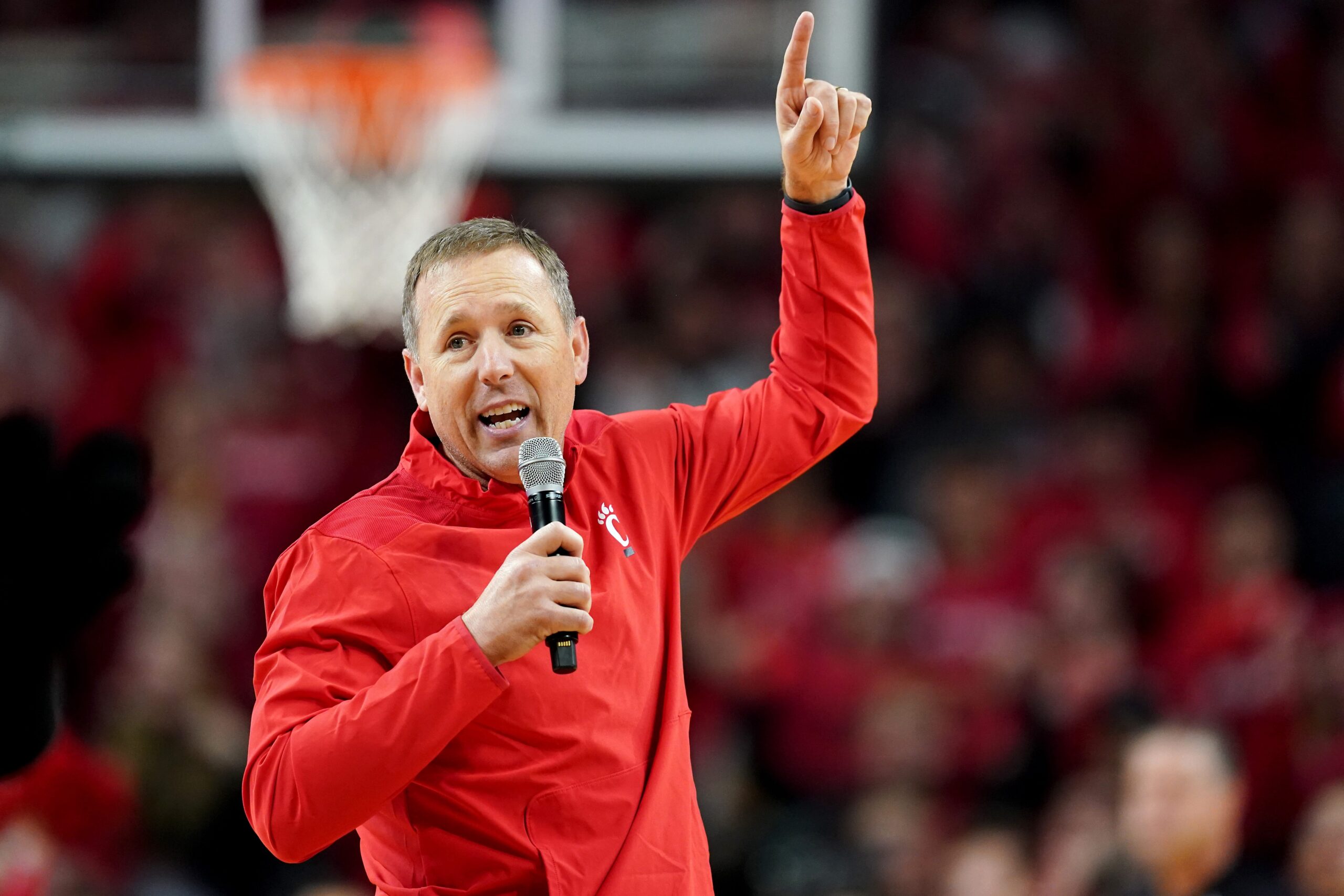 Cincinnati Bearcats head football coach Scott Satterfield speaks during a timeout in the first half of the 90th Crosstown Shootout college basketball game between the Xavier Musketeers and the Cincinnati Bearcats, Saturday, Dec. 10, 2022, at Fifth Third Arena in Cincinnati.