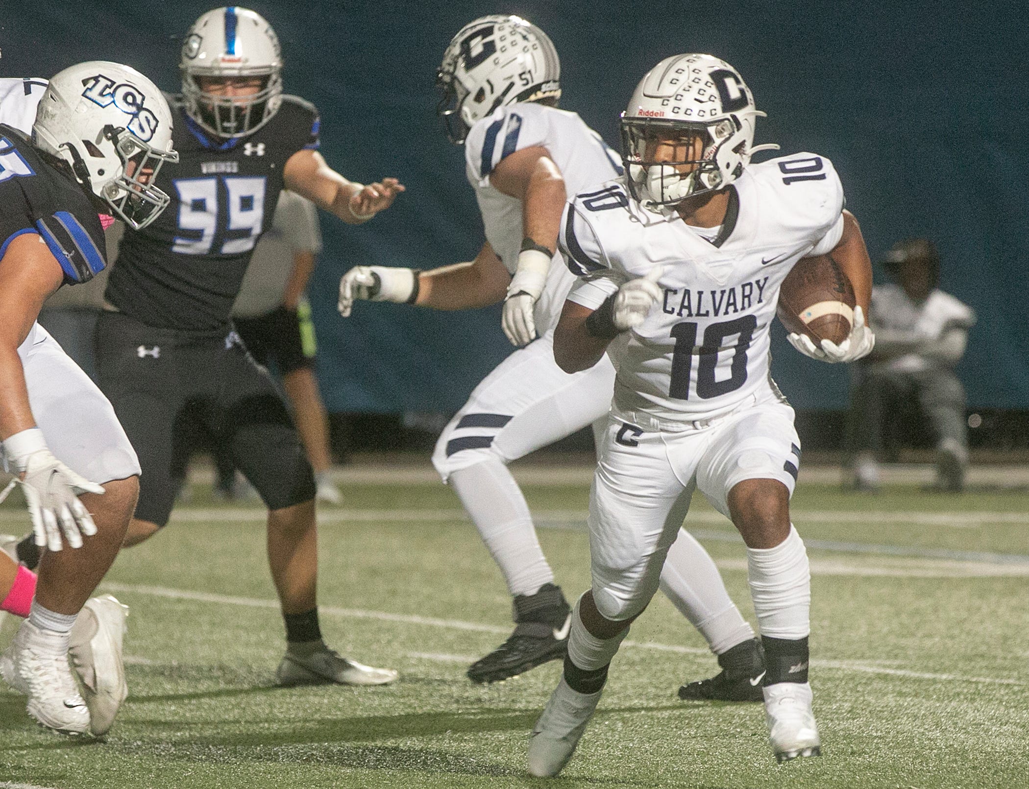 Calvary Christian School running back Sean Cuono (10) rushes the ball against Lakeland Christian School during the first half at Lakeland Christian School in Lakeland Friday night. October 21, 2022.