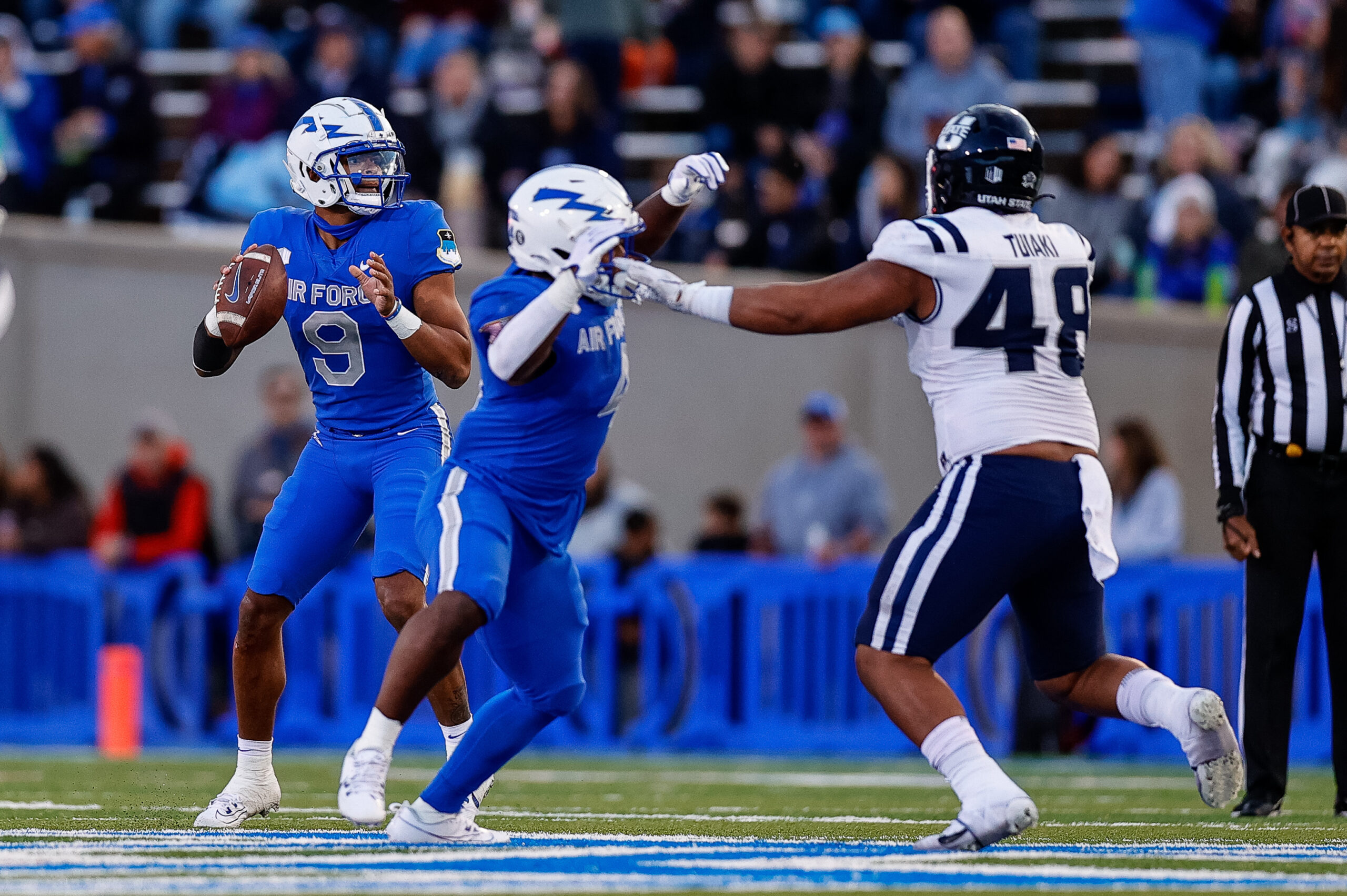 Sep 15, 2023; Colorado Springs, Colorado, USA; Air Force Falcons quarterback Zac Larrier (9) looks to pass the ball as fullback Emmanuel Michel (4) defends against Utah State Aggies defensive tackle Seni Tuiaki (48) in the second quarter at Falcon Stadium.