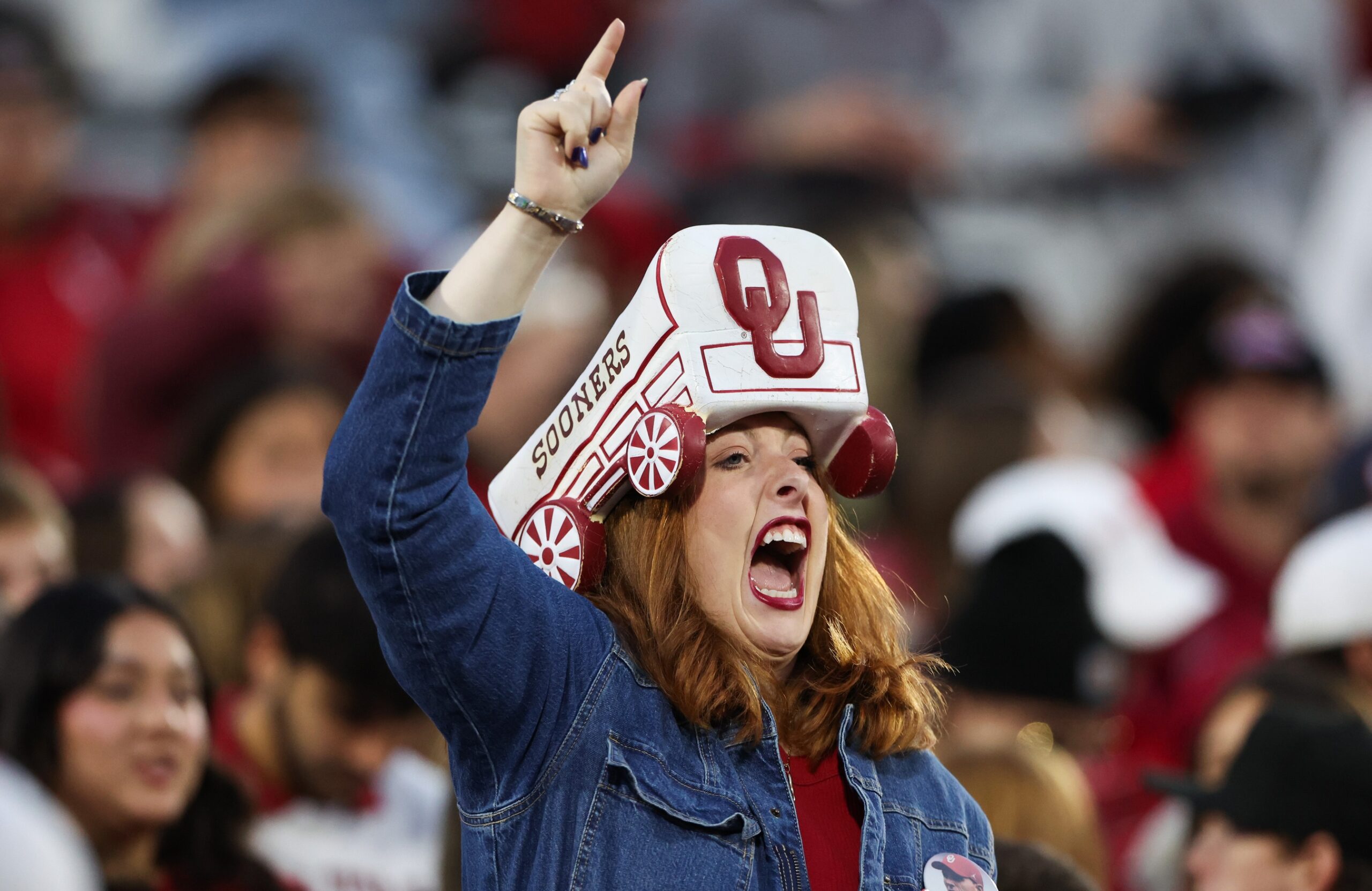 Nov 11, 2023; Norman, Oklahoma, USA; Oklahoma Sooners fan cheers before the game against the West Virginia Mountaineers at Gaylord Family-Oklahoma Memorial Stadium.