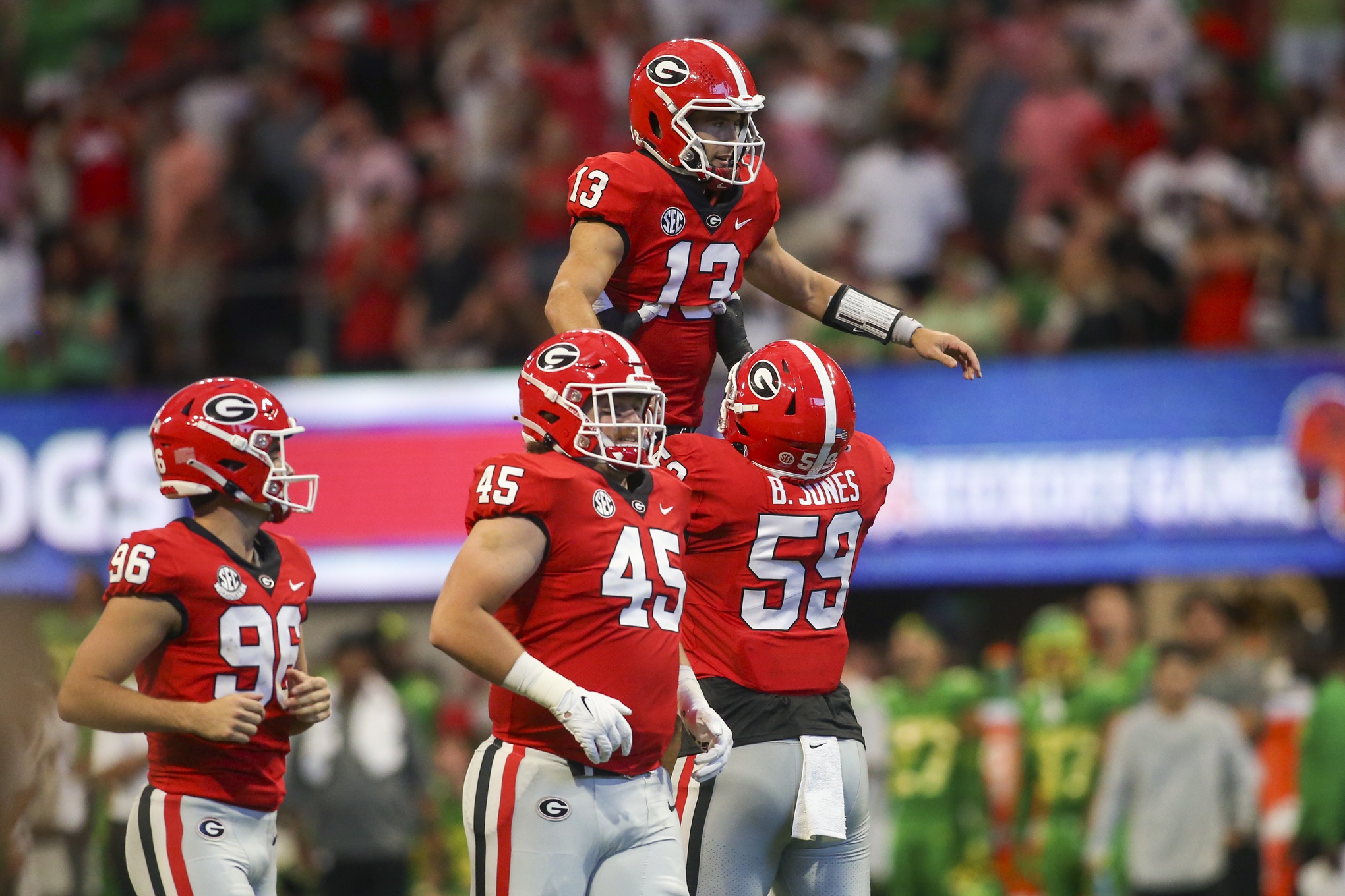 Sep 3, 2022; Atlanta, Georgia, USA; Georgia Bulldogs quarterback Stetson Bennett (13) celebrates with offensive lineman Broderick Jones (59) after a touchdown pass against the Oregon Ducks in the second quarter at Mercedes-Benz Stadium.