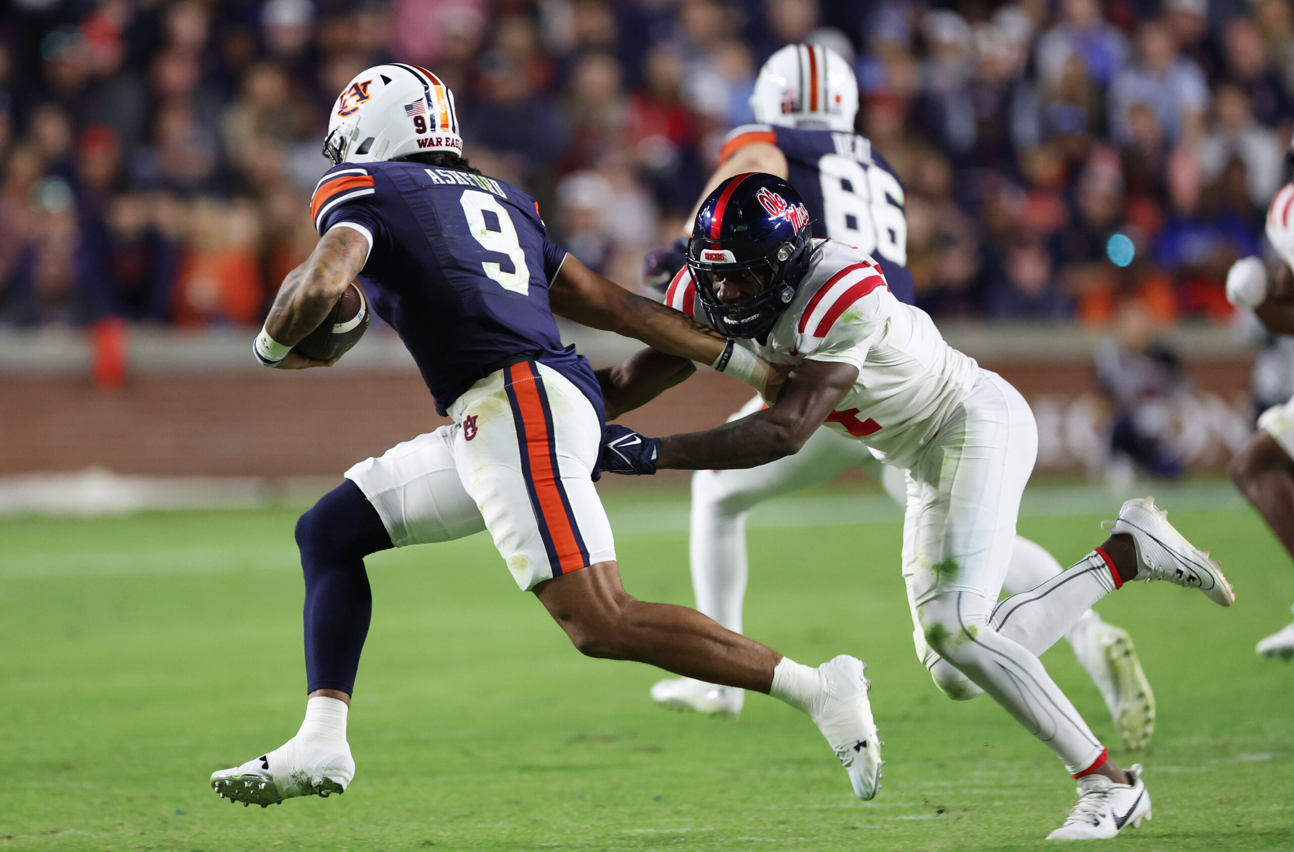 Oct 21, 2023; Auburn, Alabama, USA; Mississippi Rebels linebacker Suntarine Perkins (4) chases down Auburn Tigers quarterback Robby Ashford (9) during the third quarter at Jordan-Hare Stadium.