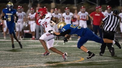 Brentwood Academy's Tamari Hill (17) runs after the catch as Brentwood's Max Orefice (53) slows him down late in the fourth quarter at James C. Parker Stadium Friday night
