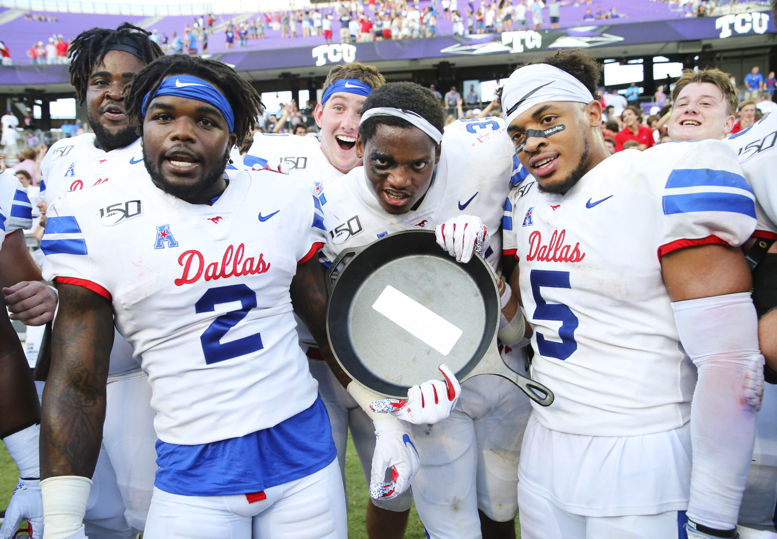 Sep 21, 2019; Fort Worth, TX, USA; Southern Methodist Mustangs players celebrate with the Iron Skillet after the victory against the TCU Horned Frogs at Amon G. Carter Stadium.