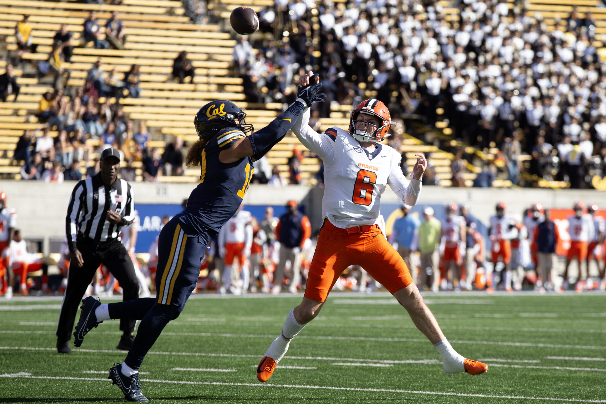 Oct 5, 2024; Berkeley, California, USA; California Golden Bears linebacker Teddye Buchanan (10) tackles Miami Hurricanes running back Damien Martinez (left) during the first quarter at California Memorial Stadium. 