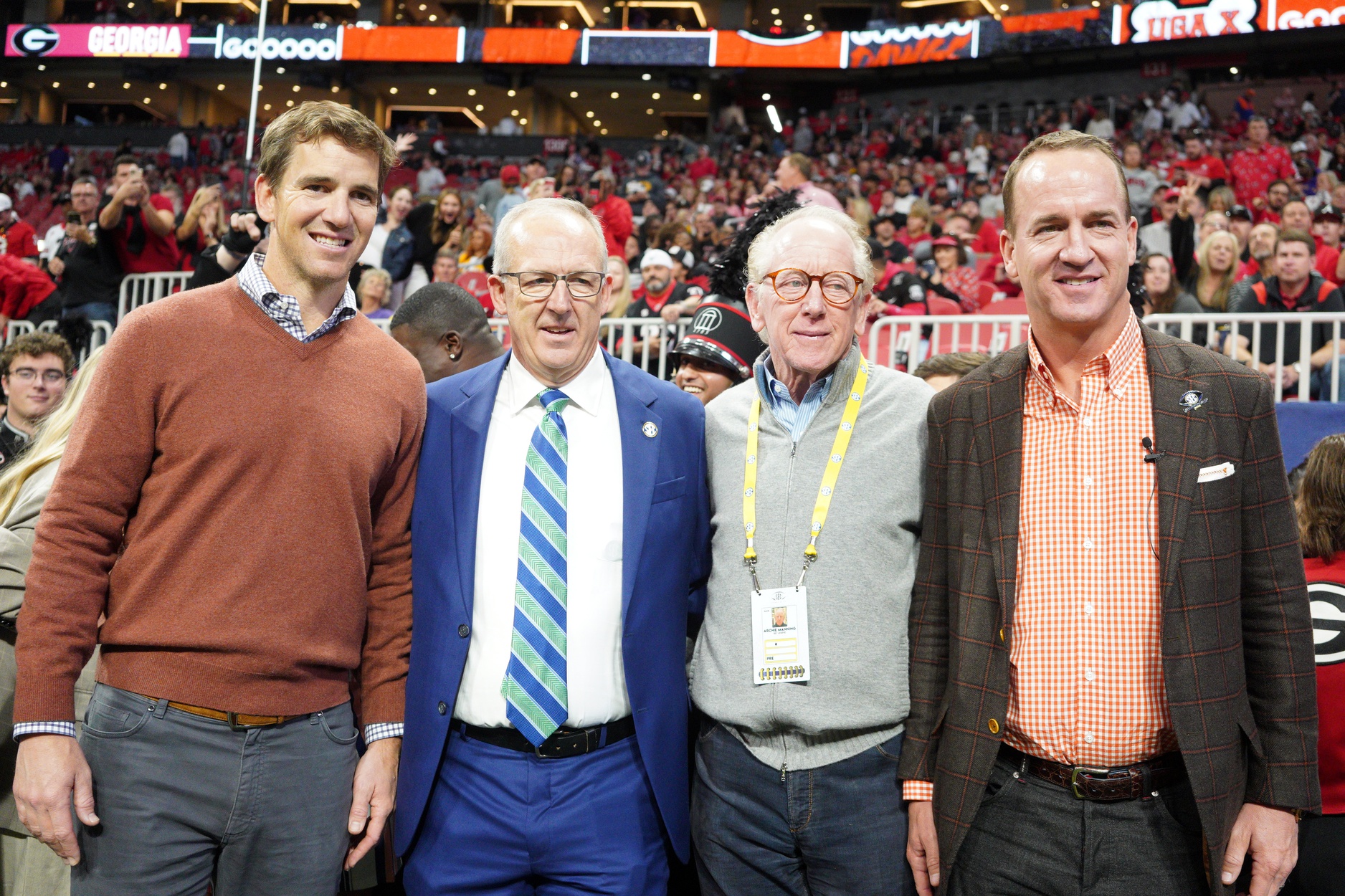 Dec 3, 2022; Atlanta, GA, USA; (L to R) Former NFL quarterbacks Eli Manning, Archie Manning, and Peyton Manning pose with SEC Commissioner Greg Sankey (2nd Left) prior to the SEC Championship game between the Georgia Bulldogs and the LSU Tigers at Mercedes-Benz Stadium.