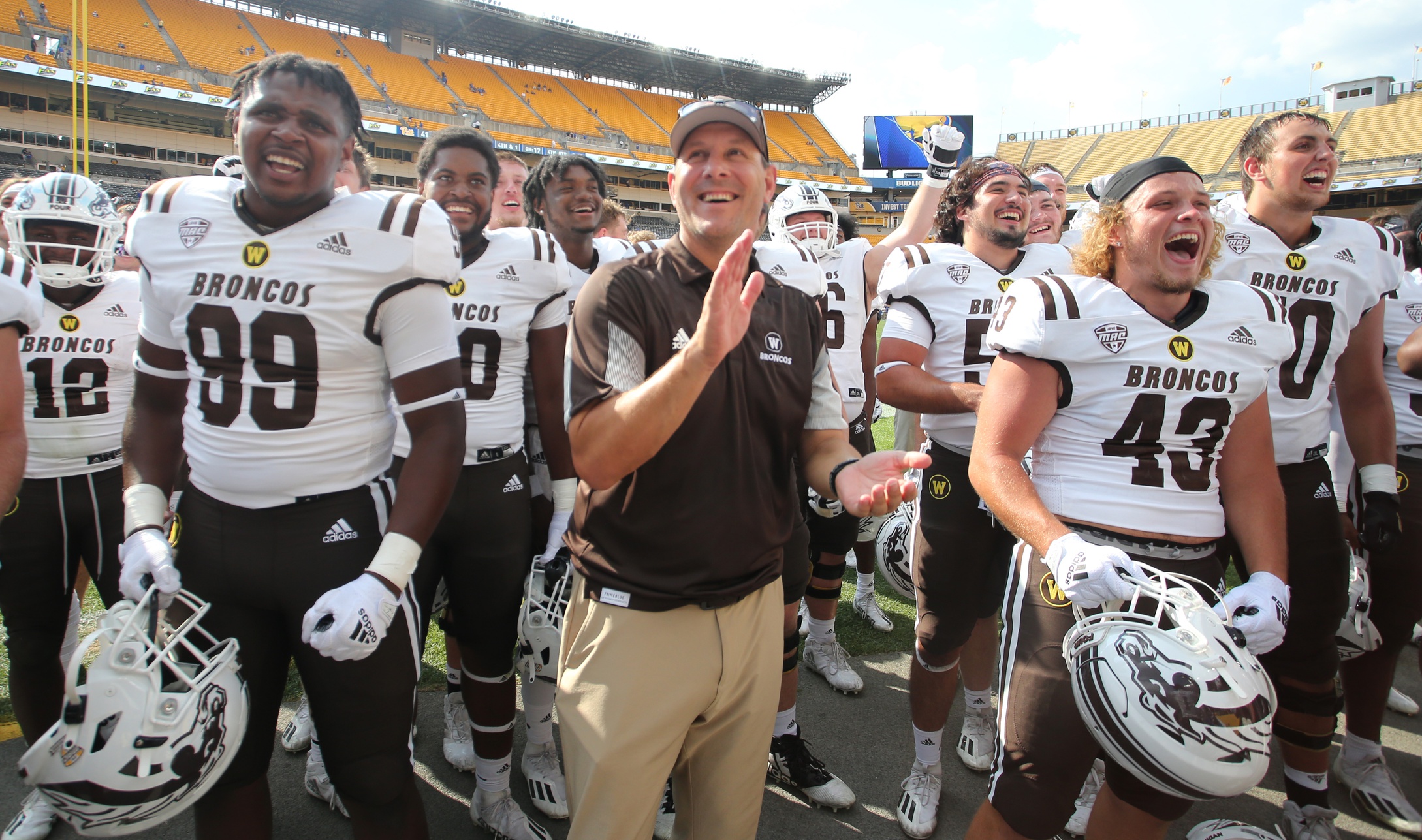 Sep 18, 2021; Pittsburgh, Pennsylvania, USA; Western Michigan Broncos head coach Tim Lester (middle) and players react to their fans after defeating the Pittsburgh Panthers at Heinz Field. The Broncos won 44-41.