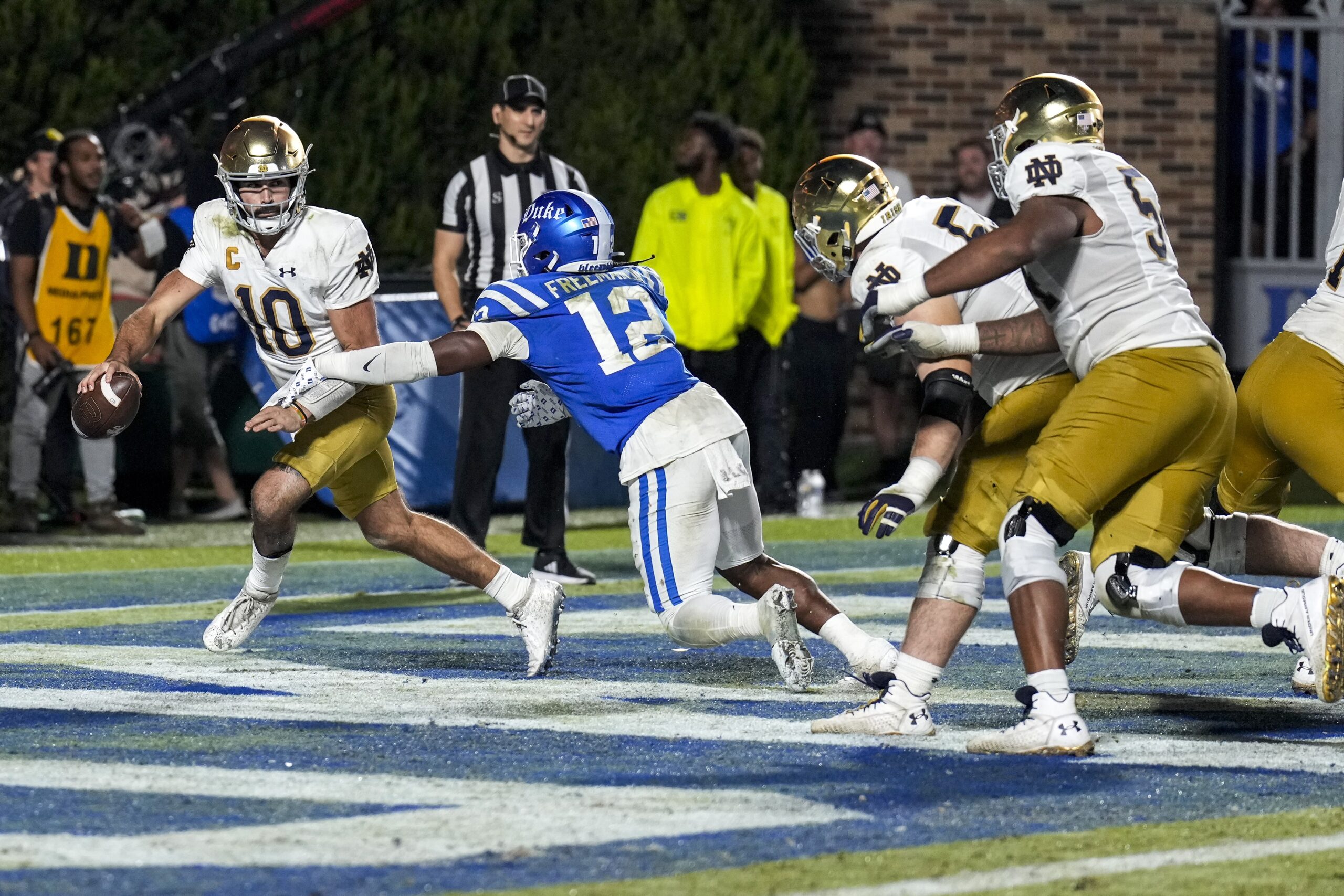 Sep 30, 2023; Durham, North Carolina, USA; Duke Blue Devils linebacker Tre Freeman (12) chases Notre Dame Fighting Irish quarterback Sam Hartman (10) in the end zone during the second half at Wallace Wade Stadium.