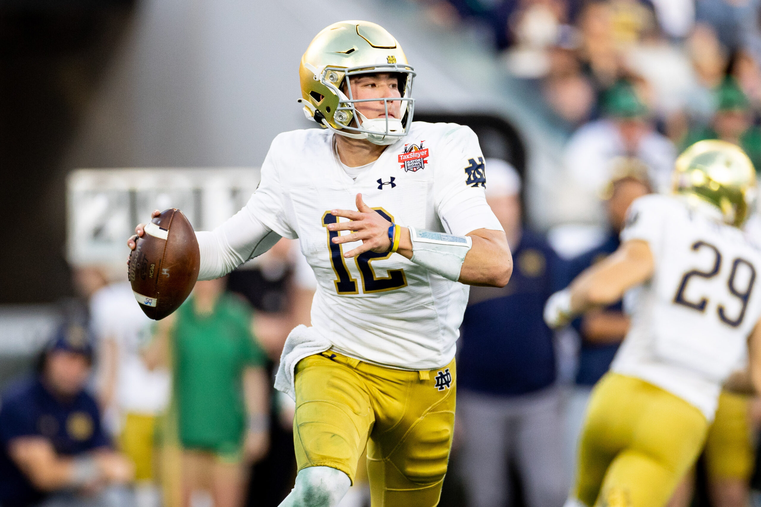 Dec 30, 2022; Jacksonville, FL, USA; Notre Dame Fighting Irish quarterback Tyler Buchner (12) looks to throw during the first half against the South Carolina Gamecocks in the 2022 Gator Bowl at TIAA Bank Field.
