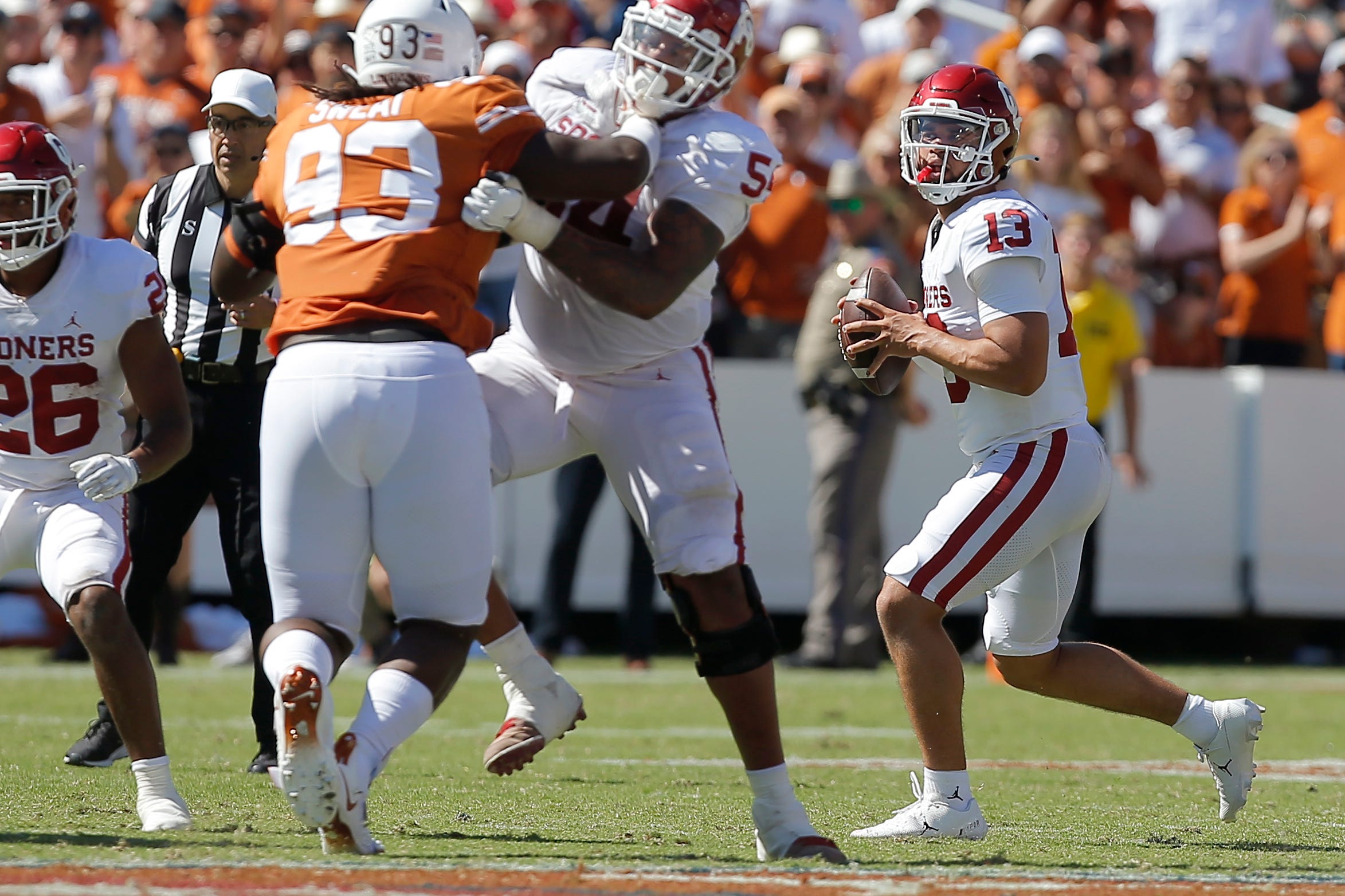 Oklahoma's Caleb Williams (13) drops back to pass during the Red River Showdown college football game between the University of Oklahoma Sooners (OU) and the University of Texas (UT) Longhorns at the Cotton Bowl in Dallas, Saturday, Oct. 9, 2021. Oklahoma won 55-48