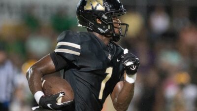 Raymond Cottrell (1) carries the ball during the Pensacola Catholic vs Milton football game at Milton High School on Thursday