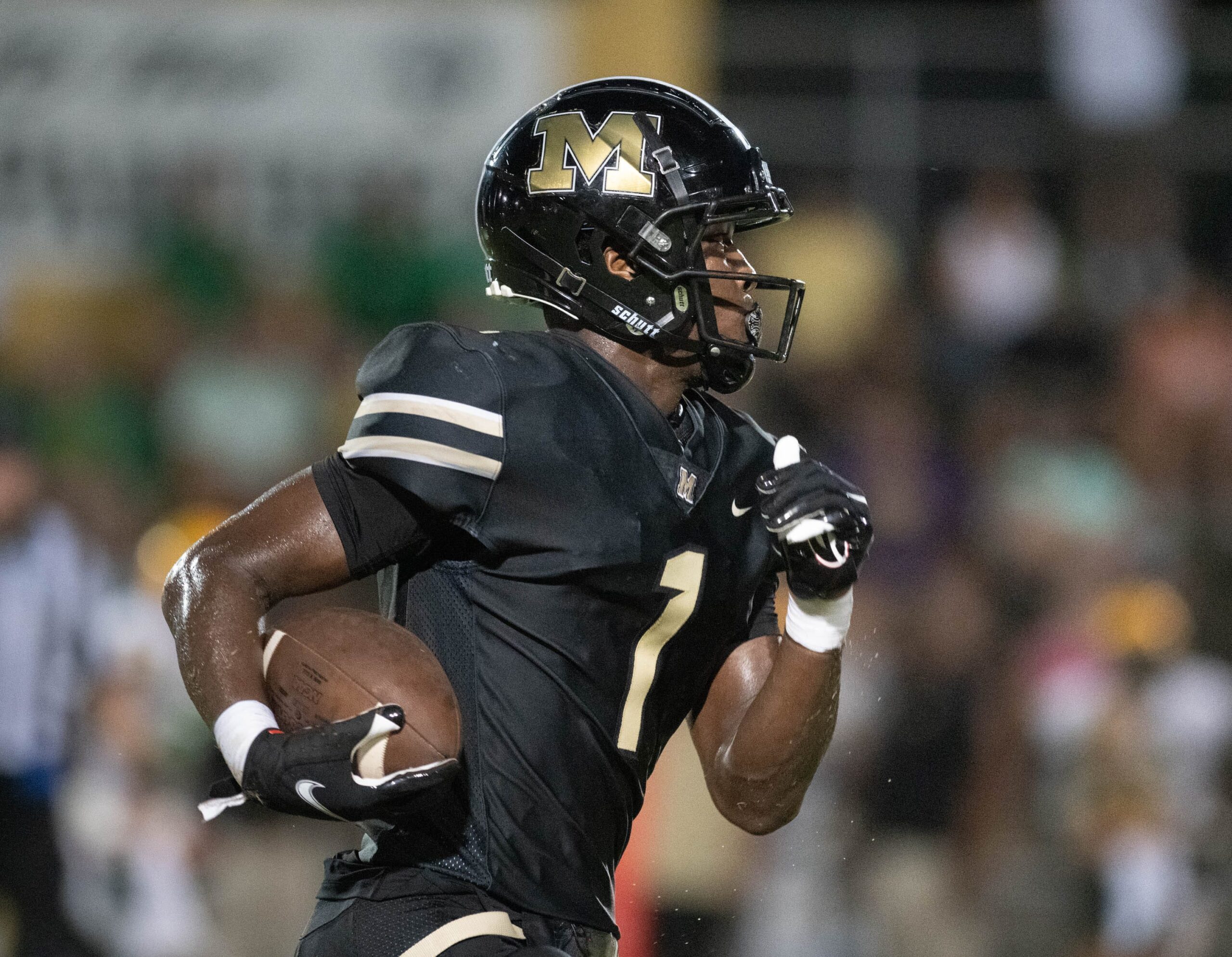 Raymond Cottrell (1) carries the ball during the Pensacola Catholic vs Milton football game at Milton High School on Thursday, Sept. 1, 2022.