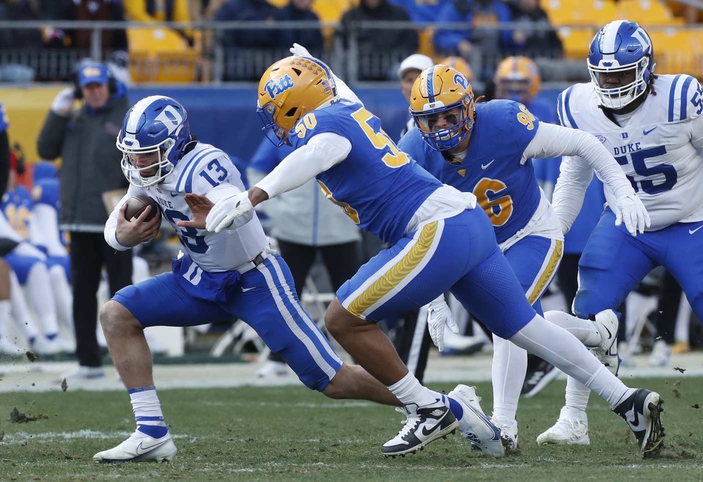 Nov 19, 2022; Pittsburgh, Pennsylvania, USA; Duke Blue Devils quarterback Riley Leonard (13) scrambles with the ball as Pittsburgh Panthers defensive lineman Dayon Hayes (50) chases during the third quarter at Acrisure Stadium. Pittsburgh won 28-26.