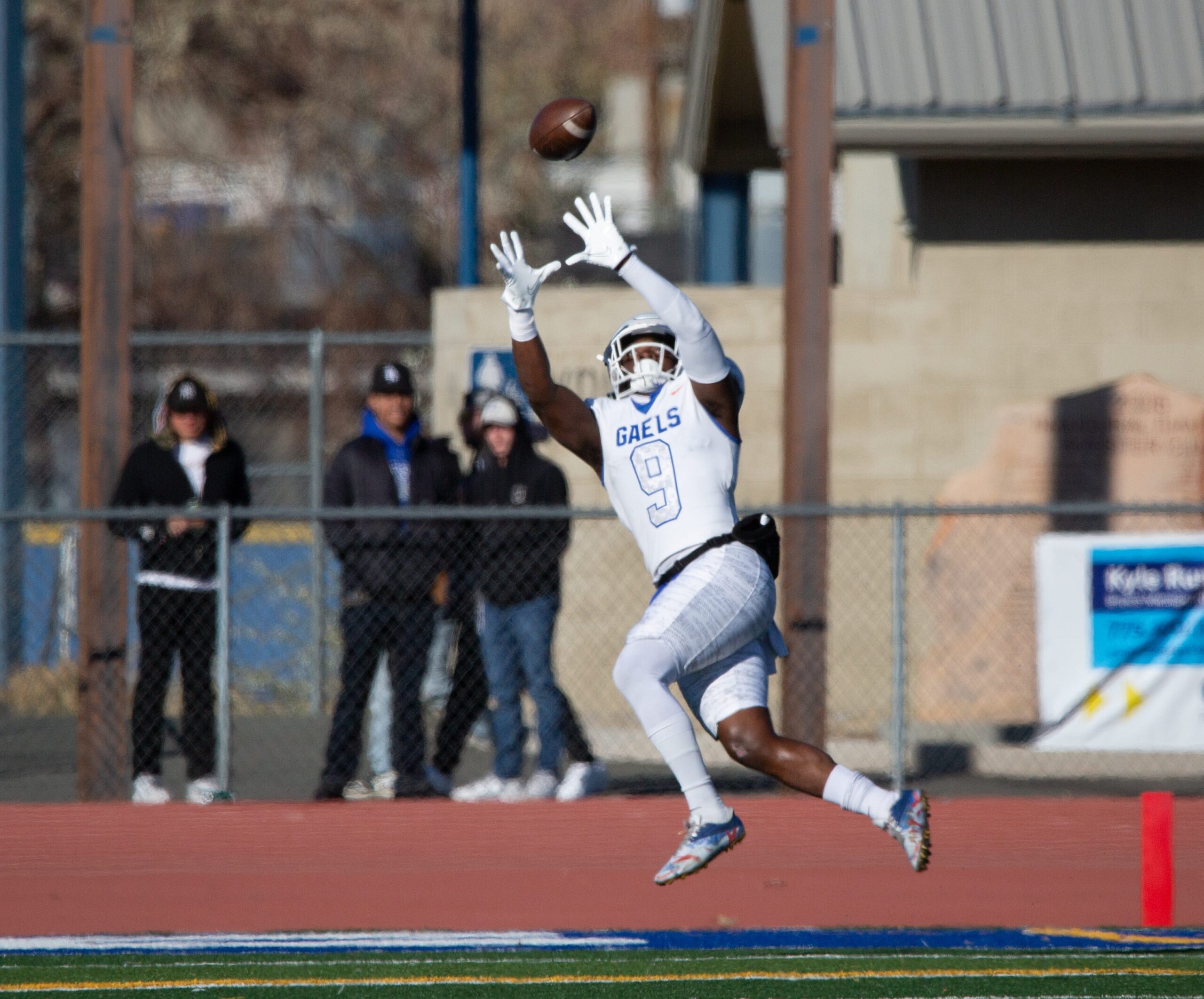 Bishop Gorman's Elija Lofton jumps to receive the ball and score a touchdown at the state championship game against Bishop Manogue at Carson High School on Nov. 19, 2022.