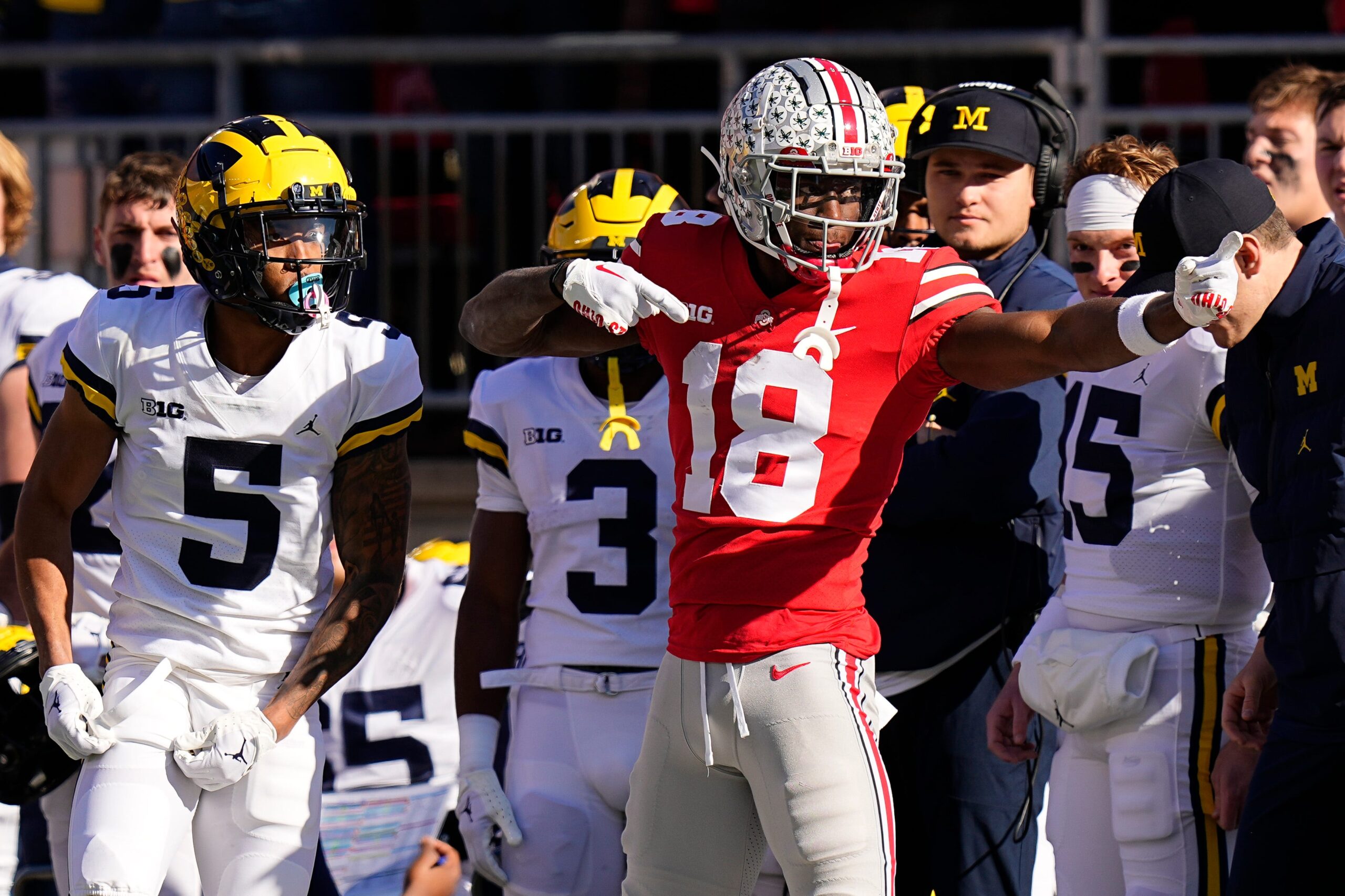 Nov 26, 2022; Columbus, Ohio, USA; Ohio State Buckeyes wide receiver Marvin Harrison Jr. (18) celebrates a first down in front of Michigan Wolverines defensive back DJ Turner (5) during the first half of the NCAA football game at Ohio Stadium.