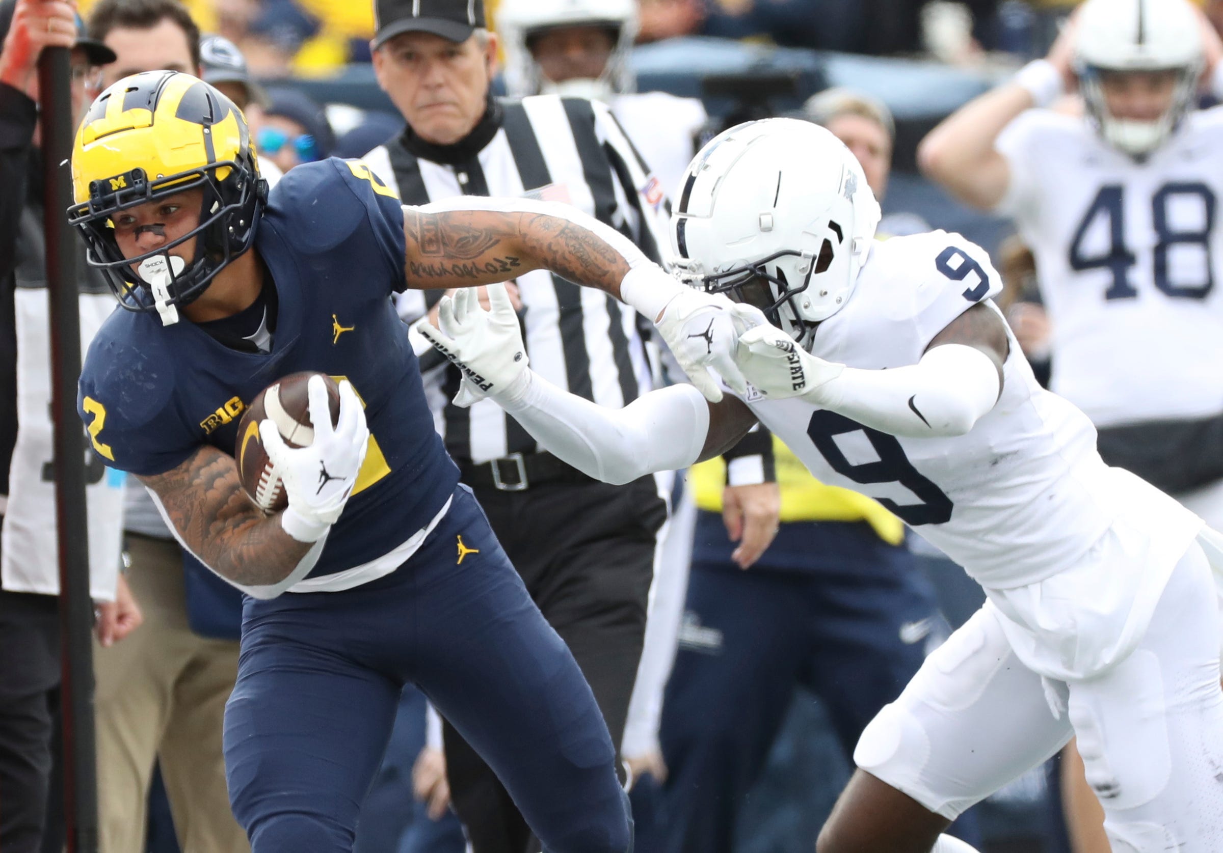 Michigan running back Blake Corum is forced out by Penn State cornerback Joey Porter Jr. during the second half Oct. 15, 2022 at Michigan Stadium in Ann Arbor.