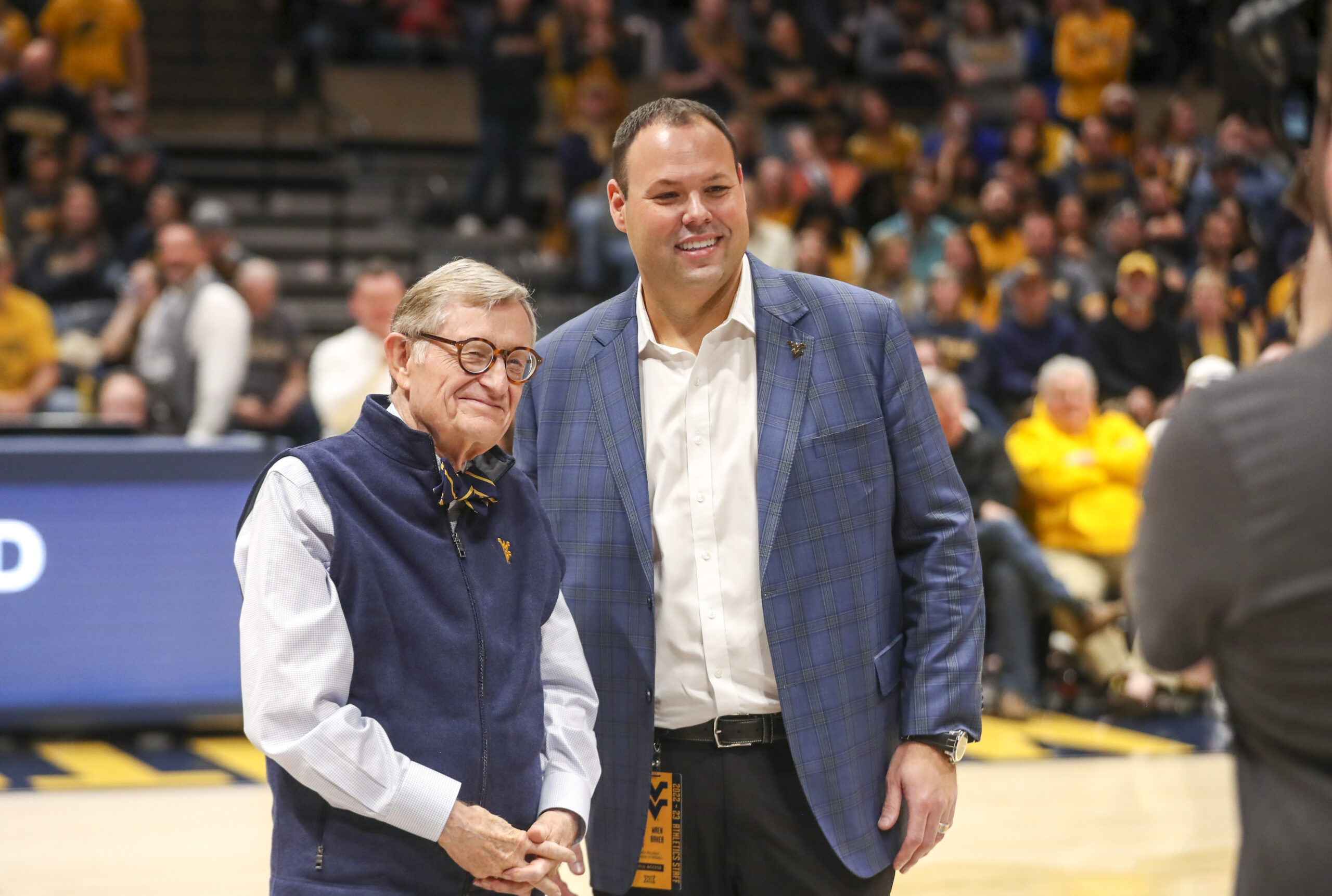 Dec 18, 2022; Morgantown, West Virginia, USA; West Virginia University President Gordon Gee welcomes new West Virginia Mountaineers Athletic Director Wren Baker during the first half against the Buffalo Bulls at WVU Coliseum.