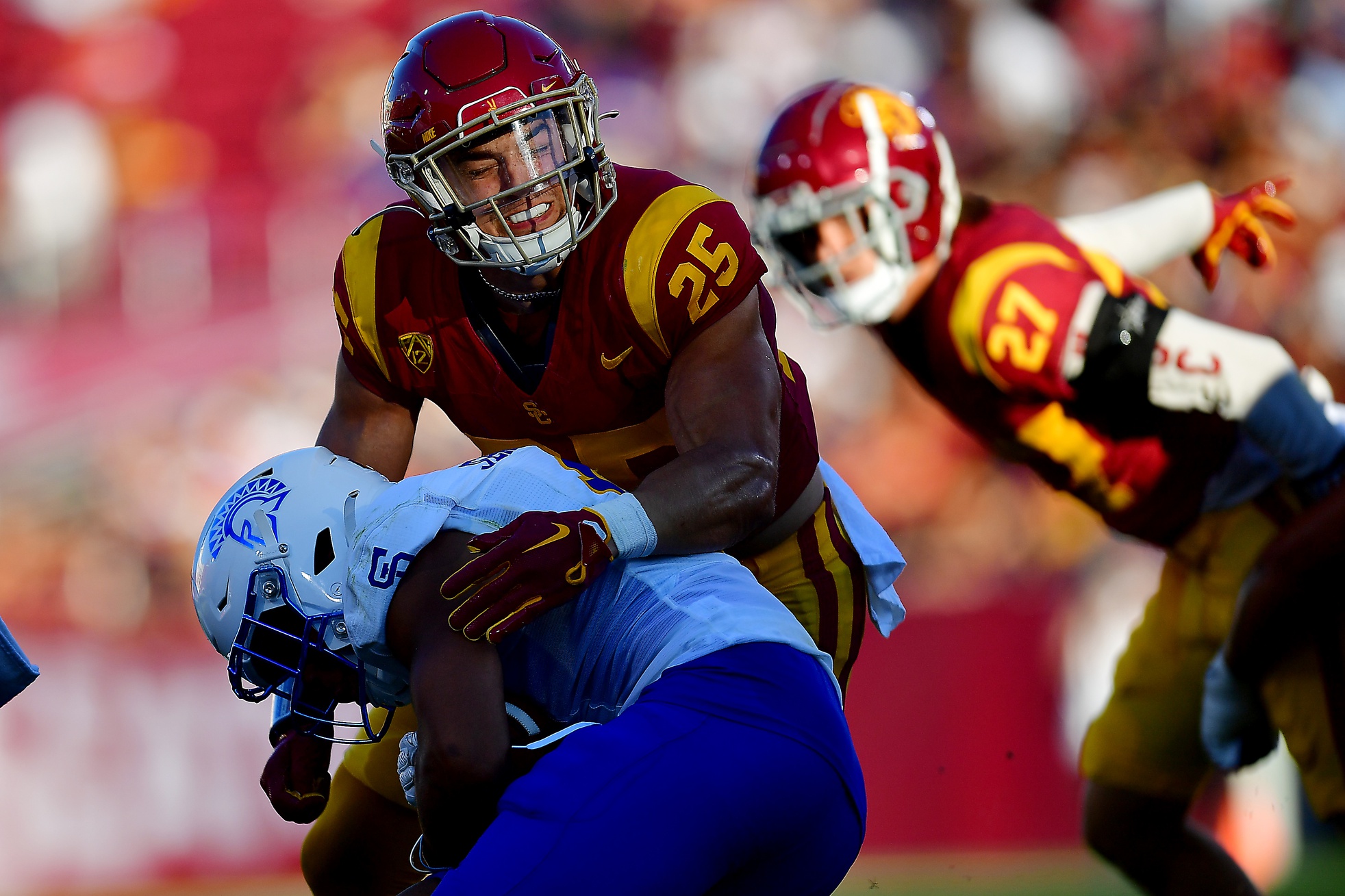 Aug 26, 2023; Los Angeles, California, USA; Southern California Trojans linebacker Tackett Curtis (25) brings down San Jose State Spartans wide receiver Isaac Jernagin (0) during the first half at Los Angeles Memorial Coliseum.
