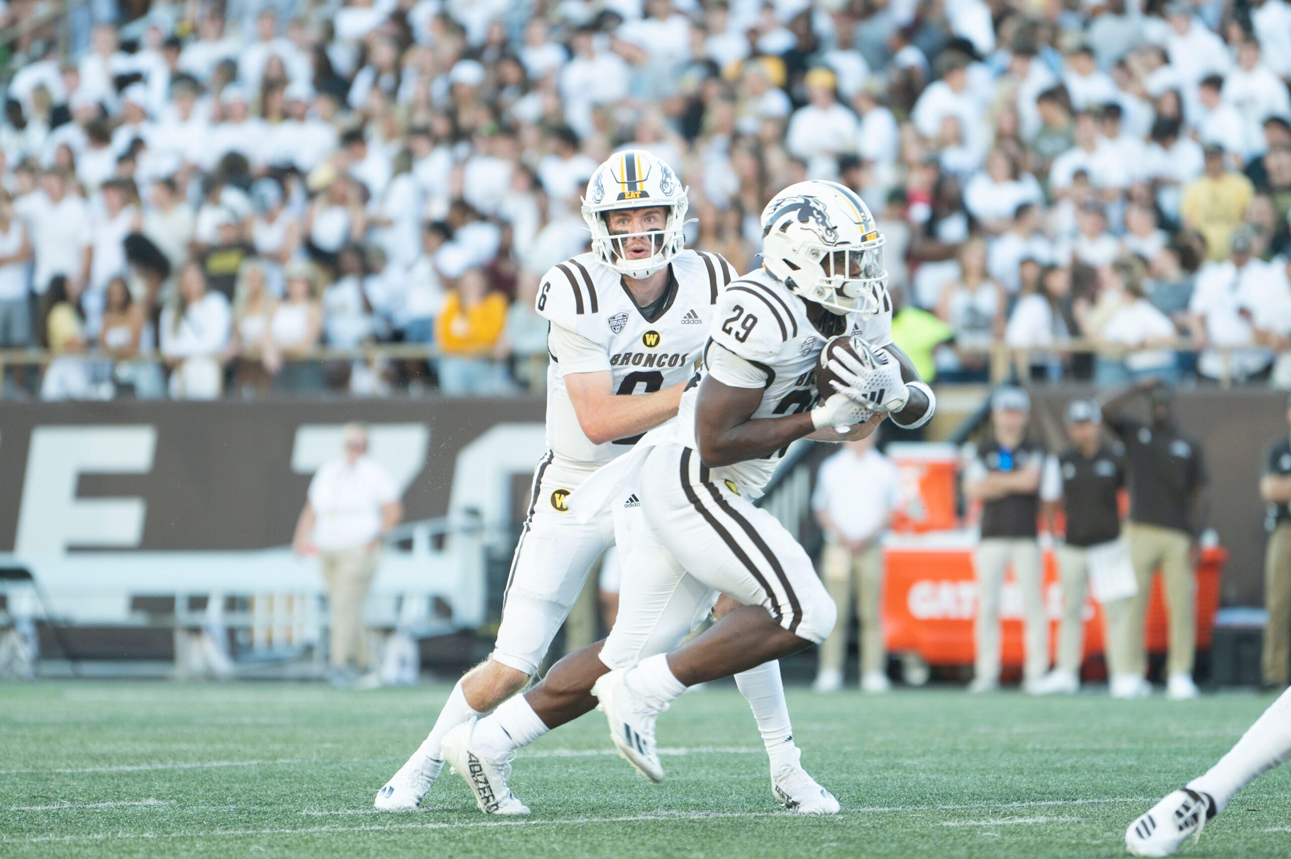 Western Michigan quarterback Jack Salopek hands off to running back Jalen Buckley during the season opening game against Saint Francis at Waldo Stadium on Thursday, Aug. 31, 2023.