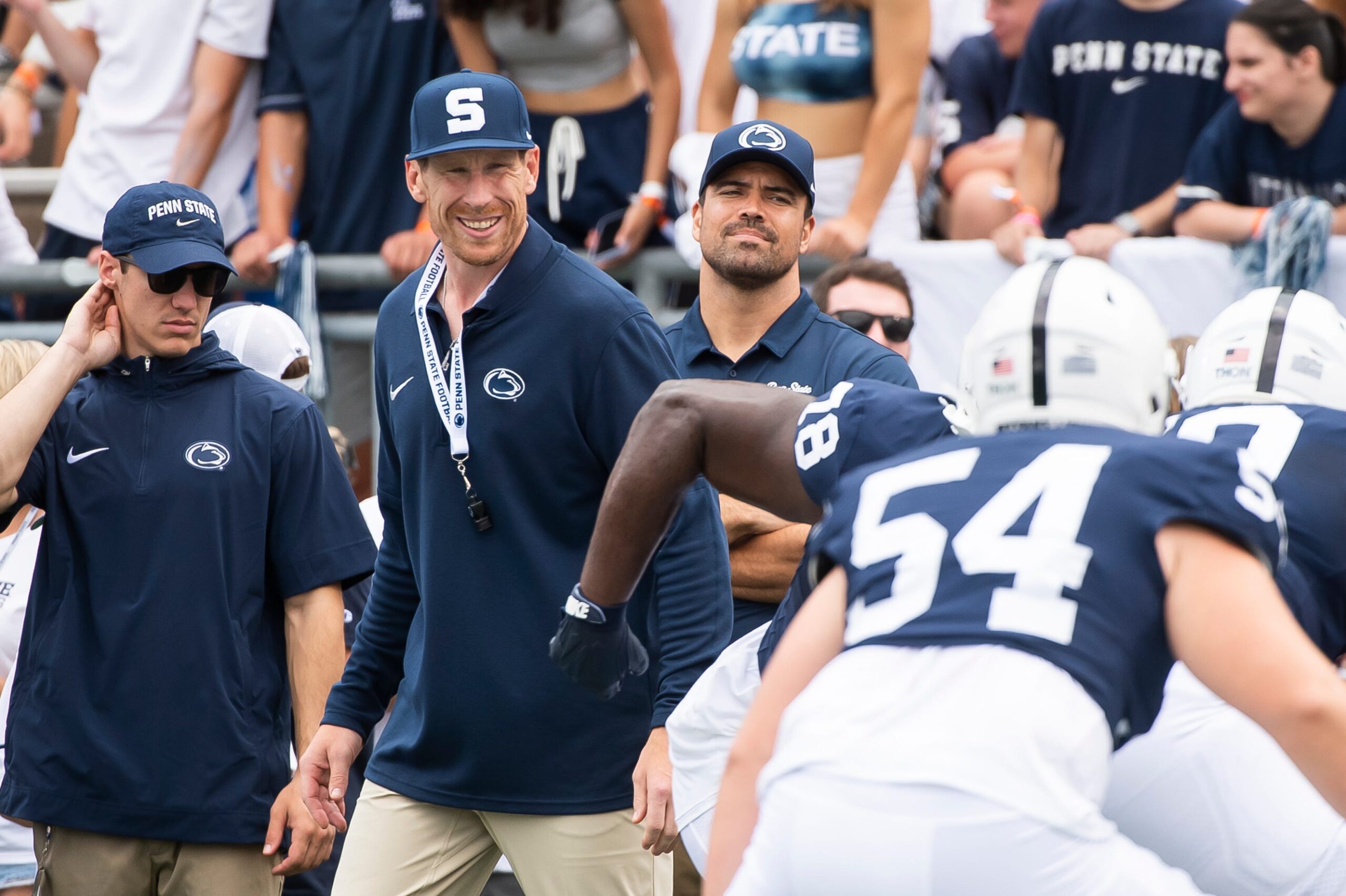 Penn State offensive line coach Phil Trautwein (second from left) smiles as he watches the line warm up before a NCAA football game against Delaware Saturday, Sept. 9, 2023, in State College, Pa.