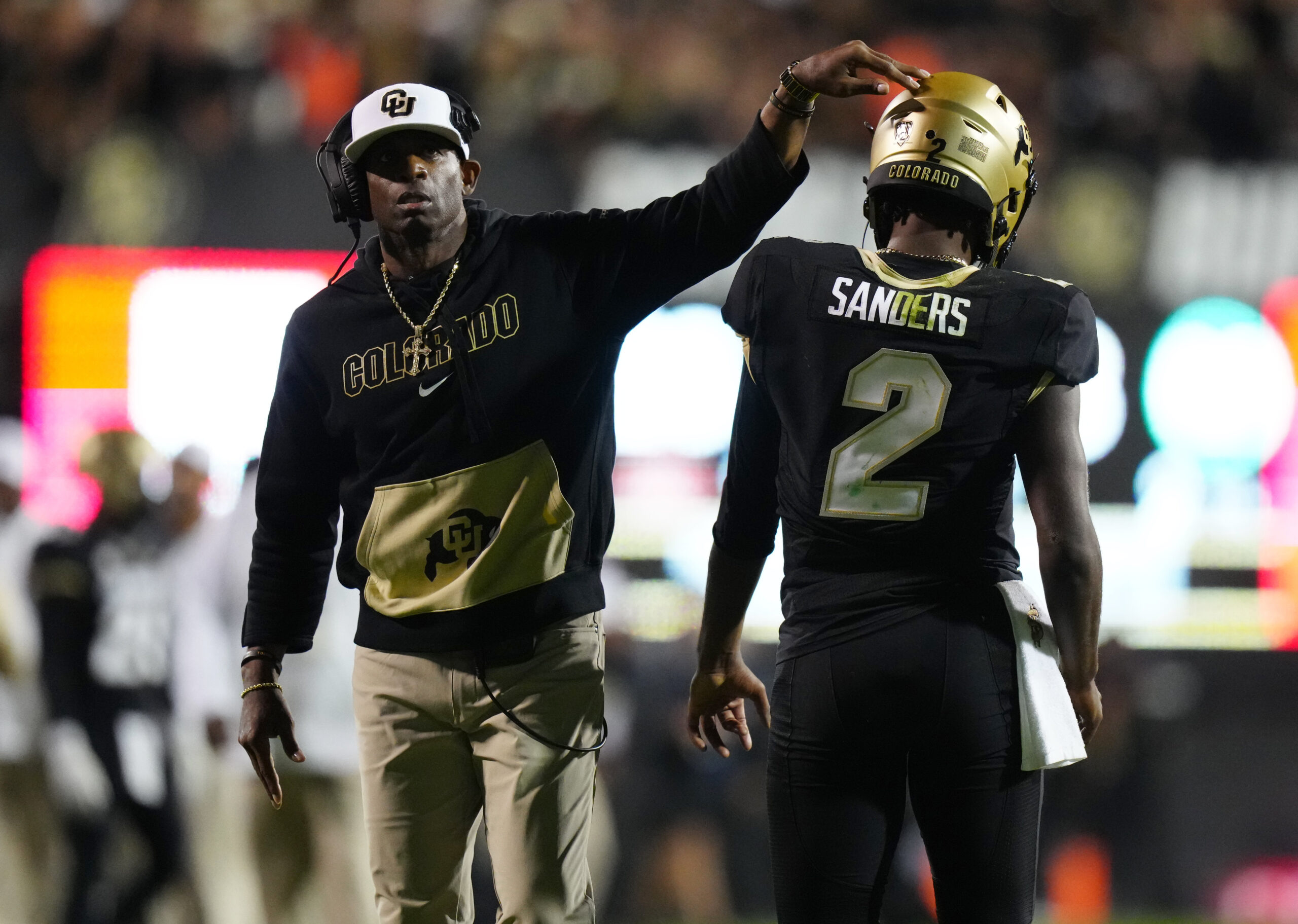 Colorado Buffaloes quarterback Shedeur Sanders (2) and head coach Deion Sanders following a two-point conversion in the fourth quarter against the Colorado State Rams.