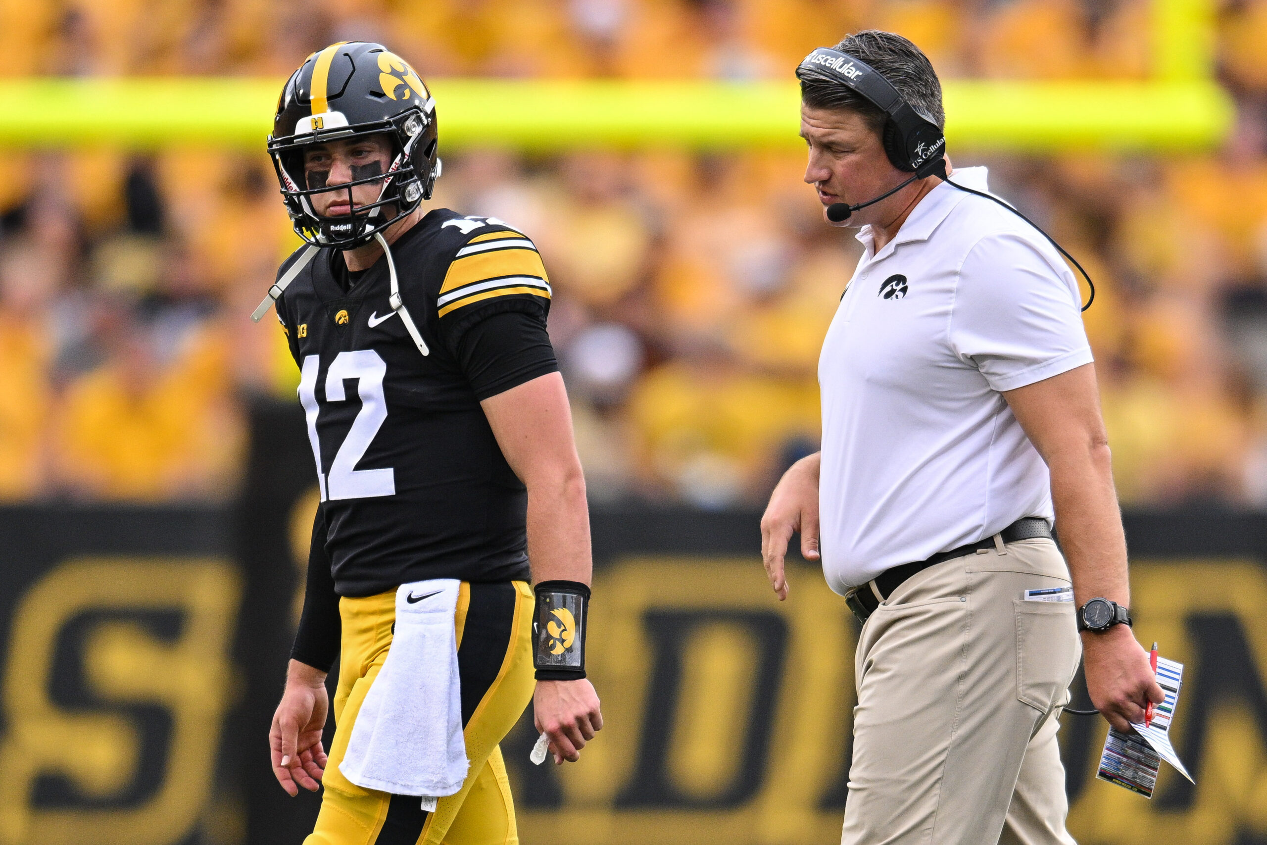 Sep 16, 2023; Iowa City, Iowa, USA; Iowa Hawkeyes assistant head coach Brian Ferentz and quarterback Cade McNamara (12) look on during the game against the Western Michigan Broncos at Kinnick Stadium.