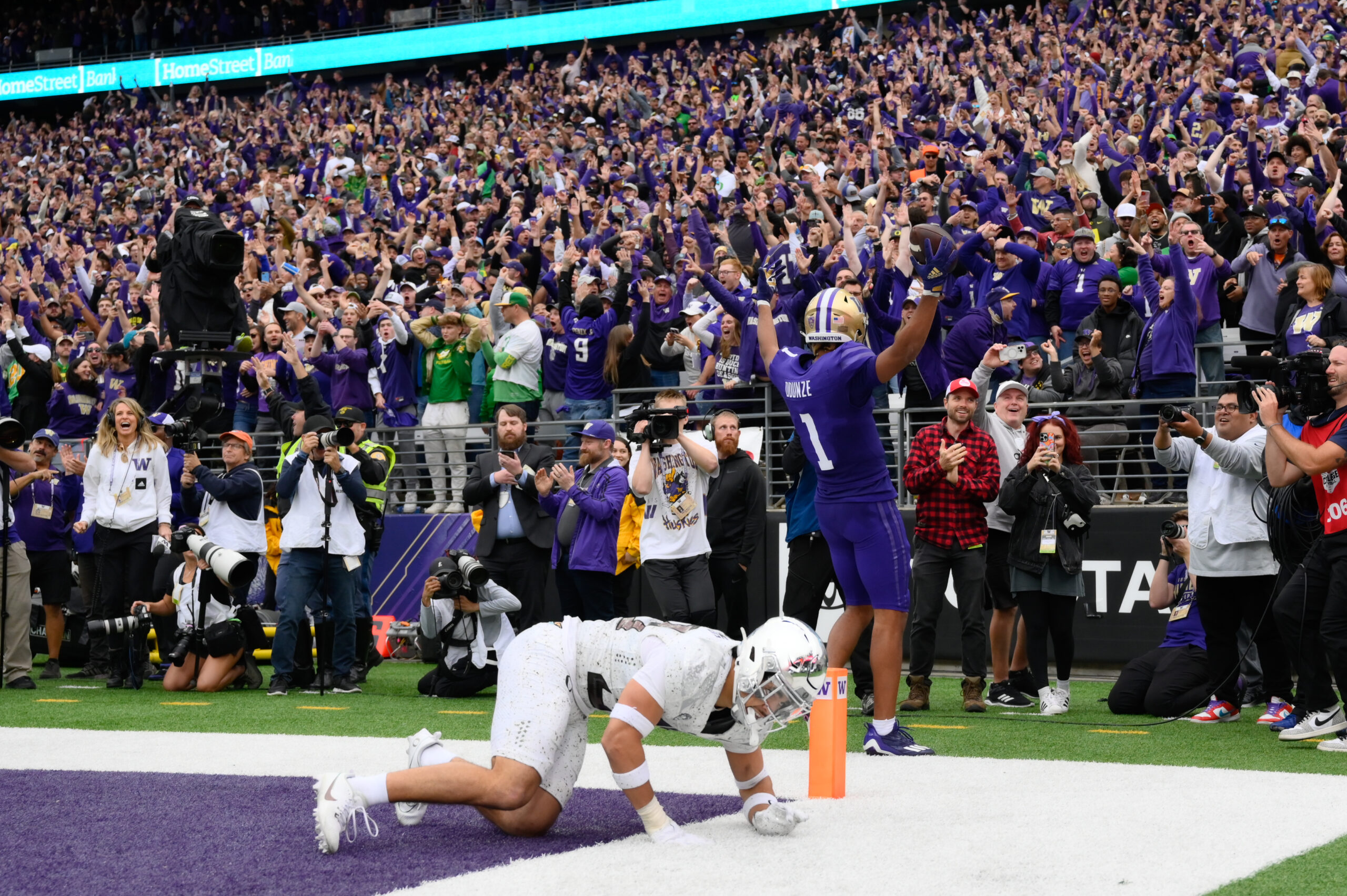 Oct 14, 2023; Seattle, Washington, USA; Washington Huskies wide receiver Rome Odunze (1) celebrates scoring a touchdown against the Oregon Ducks in the late fourth quarter at Alaska Airlines Field at Husky Stadium.