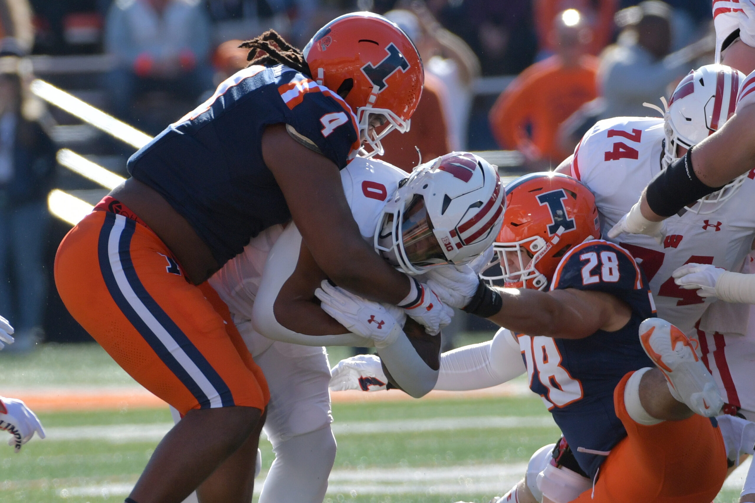 Oct 21, 2023; Champaign, Illinois, USA; Illinois Fighting Illini defensive tackle Jer'Zhan Newton (4) tackles Wisconsin Badgers running back Braelon Allen (0) during the first half at Memorial Stadium.