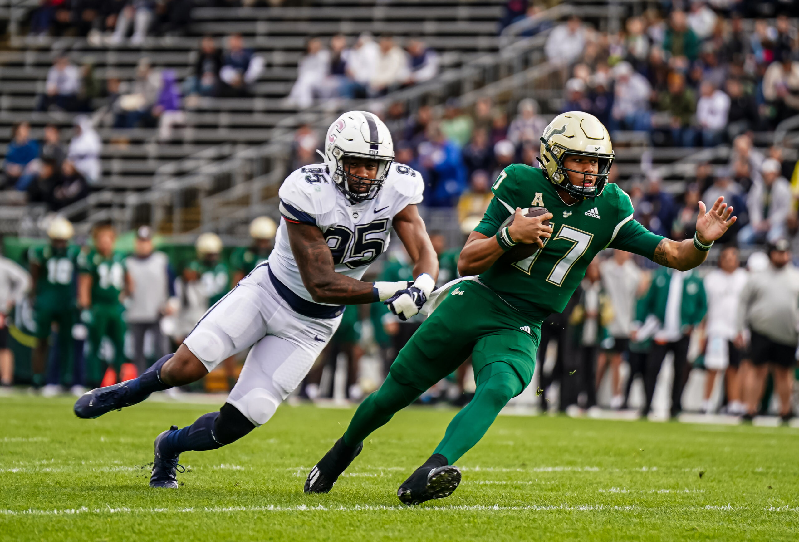 Oct 21, 2023; East Hartford, Connecticut, USA; South Florida Bulls quarterback Byrum Brown (17) runs the ball against UConn Huskies defensive lineman Eric Watts (95) in the first quarter at Rentschler Field at Pratt & Whitney Stadium.