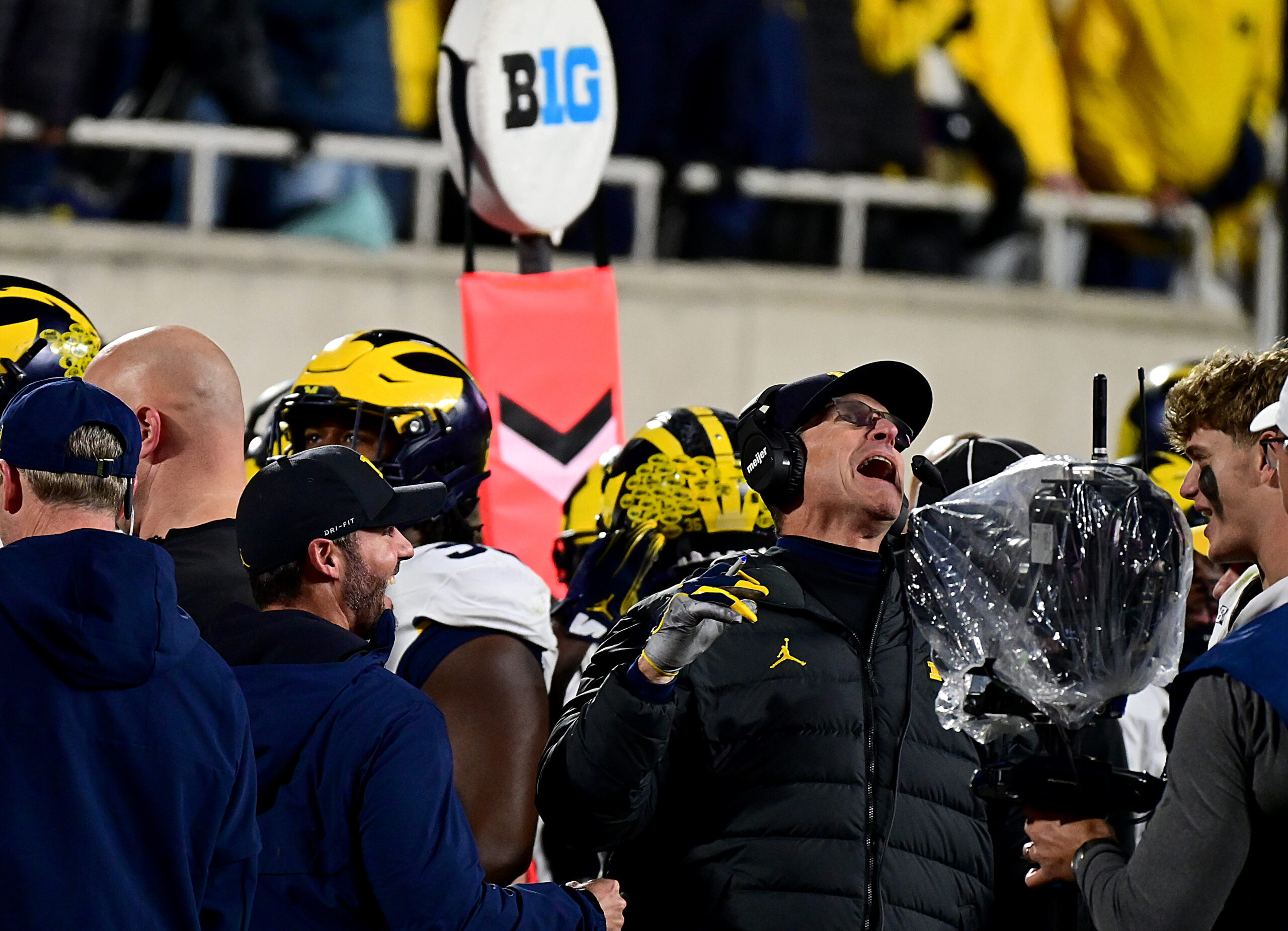 Wolverines head coach Jim Harbaugh shouts and grins after a turnover late in the game took the ball away from the Michigan State Spartans at Spartan Stadium.