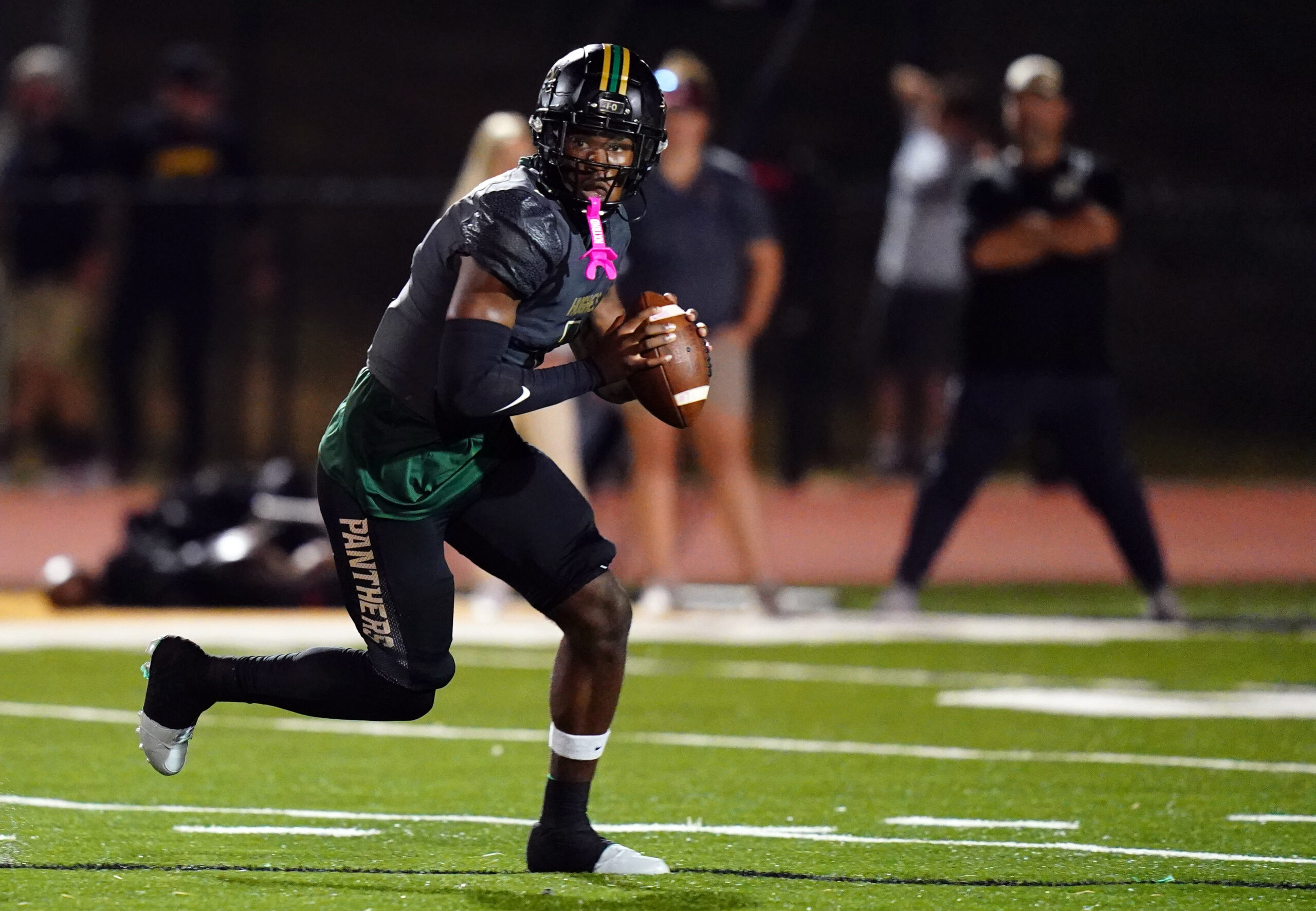 Oct 27, 2023; Fairburn, GA, USA; Langston Hughes Panthers quarterback Air Noland (1) scrambles out of the pocket during the first half against the South Paulding Spartans at Panther Stadium.