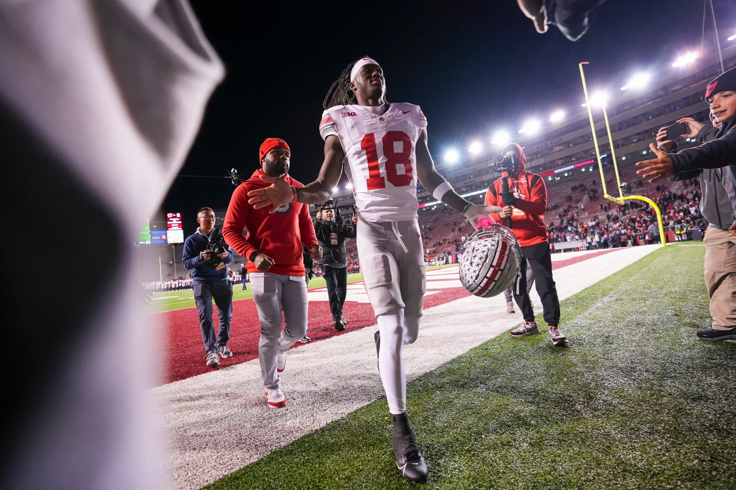 Ohio State Buckeyes wide receiver Marvin Harrison Jr. (18) gets high fives as he leaves the field.