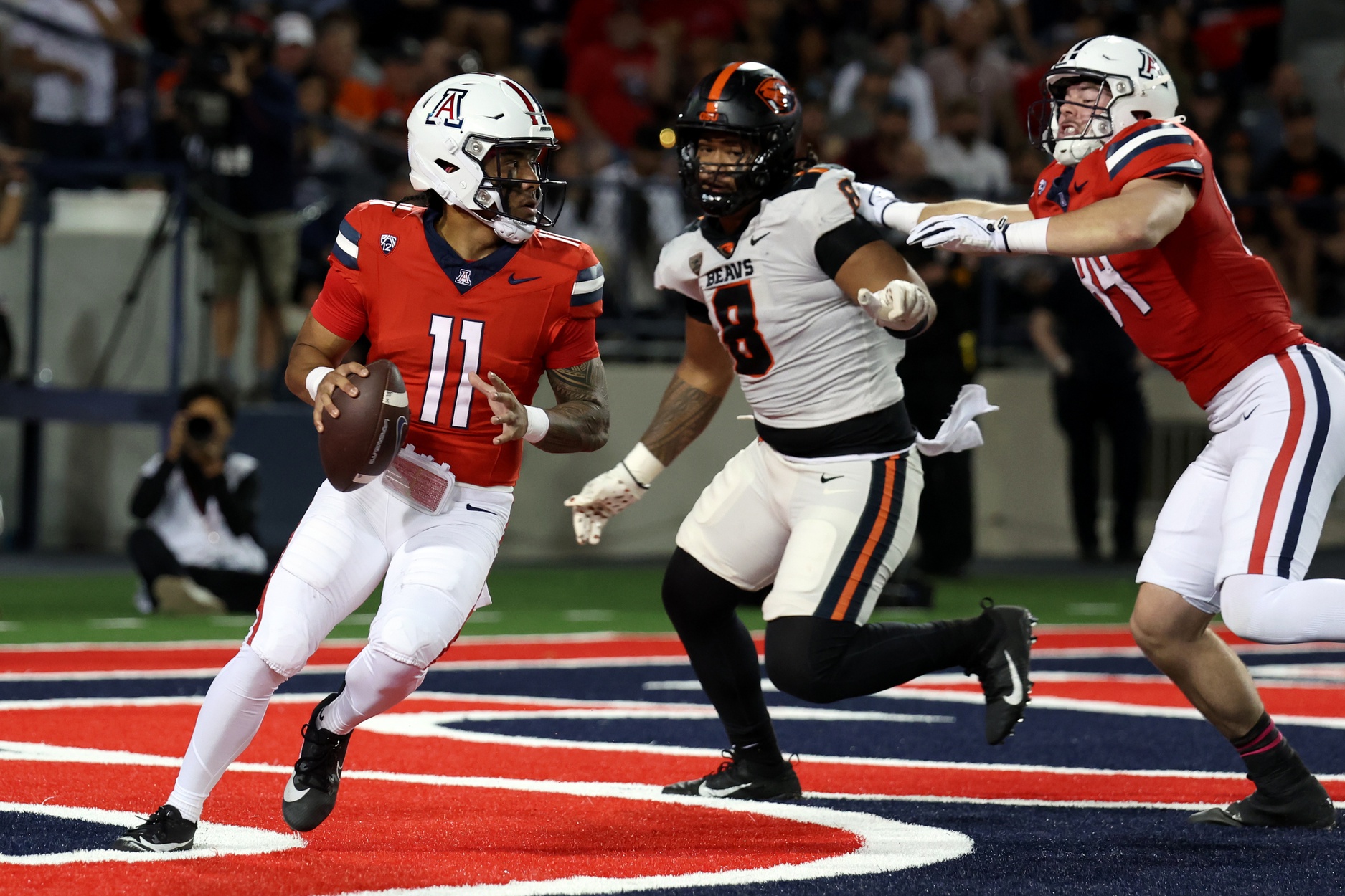 Oct 28, 2023; Tucson, Arizona, USA; Arizona Wildcats quarterback Noah Fifita #11 drops back to make a pass against Oregon State Beavers defensive lineman Sione Lolohea #8 during the first half at Arizona Stadium.