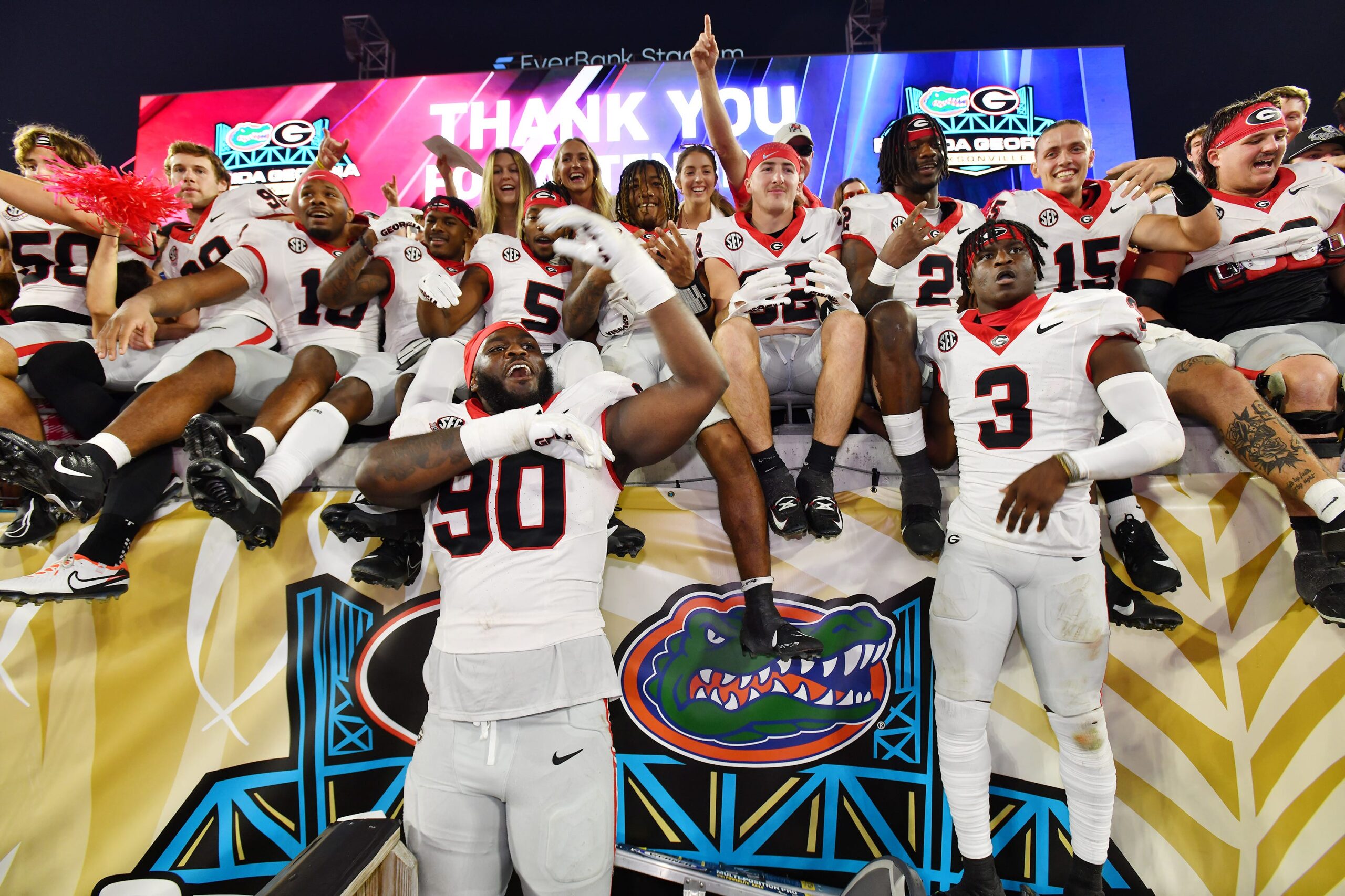 Georgia players celebrate in the stands with fans after their victory over the Florida Gators.