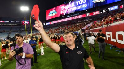 Georgia Bulldogs head coach Kirby Smart thanks fans as he runs down the sideline after Saturday night's victory over the Gators. The annual Florida vs Georgia football game at EverBank Stadium in Jacksonville