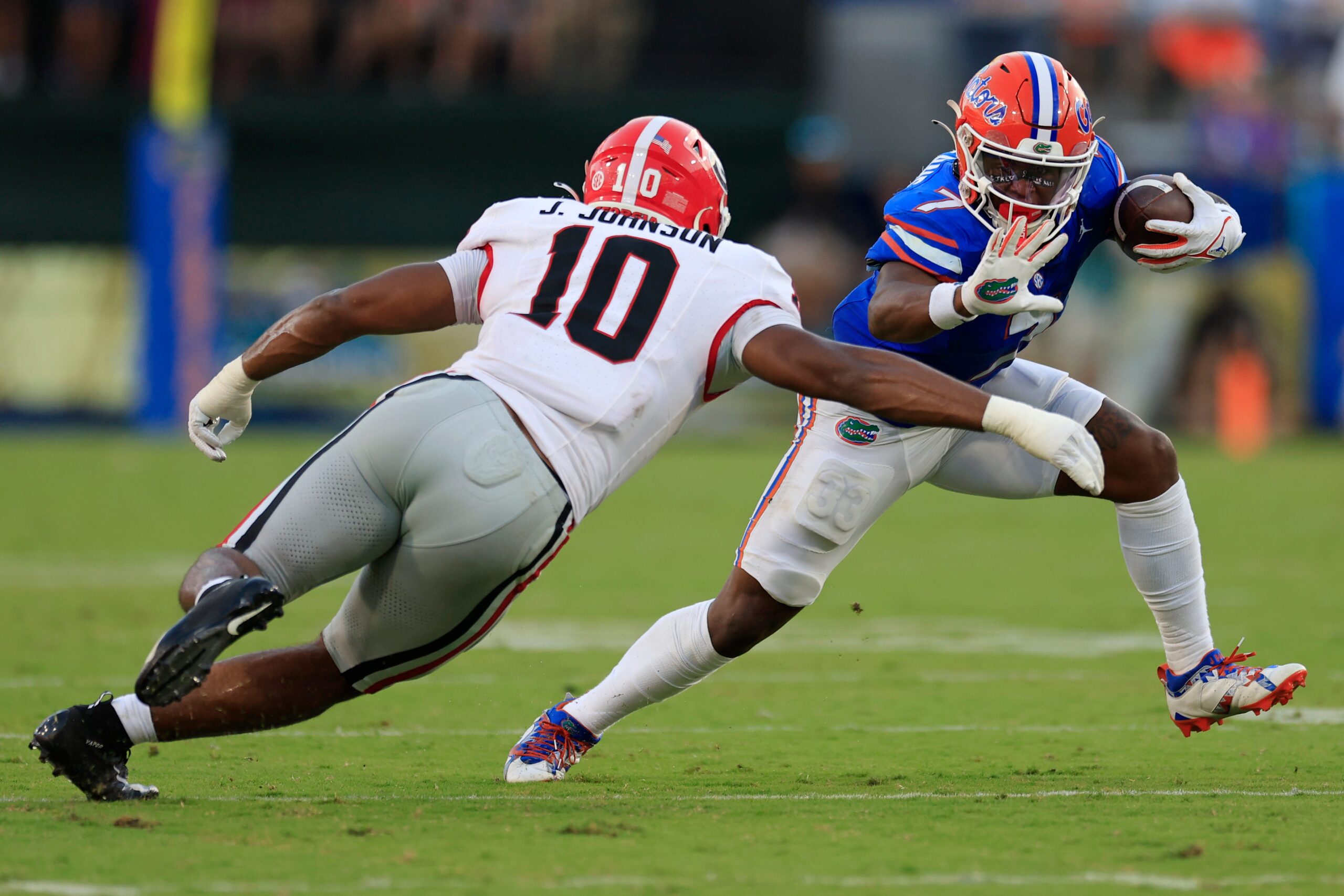 Georgia Bulldogs linebacker Jamon Dumas-Johnson (10) tackles Florida Gators running back Trevor Etienne (7) during the third quarter of an NCAA football game Saturday, Oct. 28, 2023 at EverBank Stadium in Jacksonville, Fla. Georgia defeated Florida 43-20.
