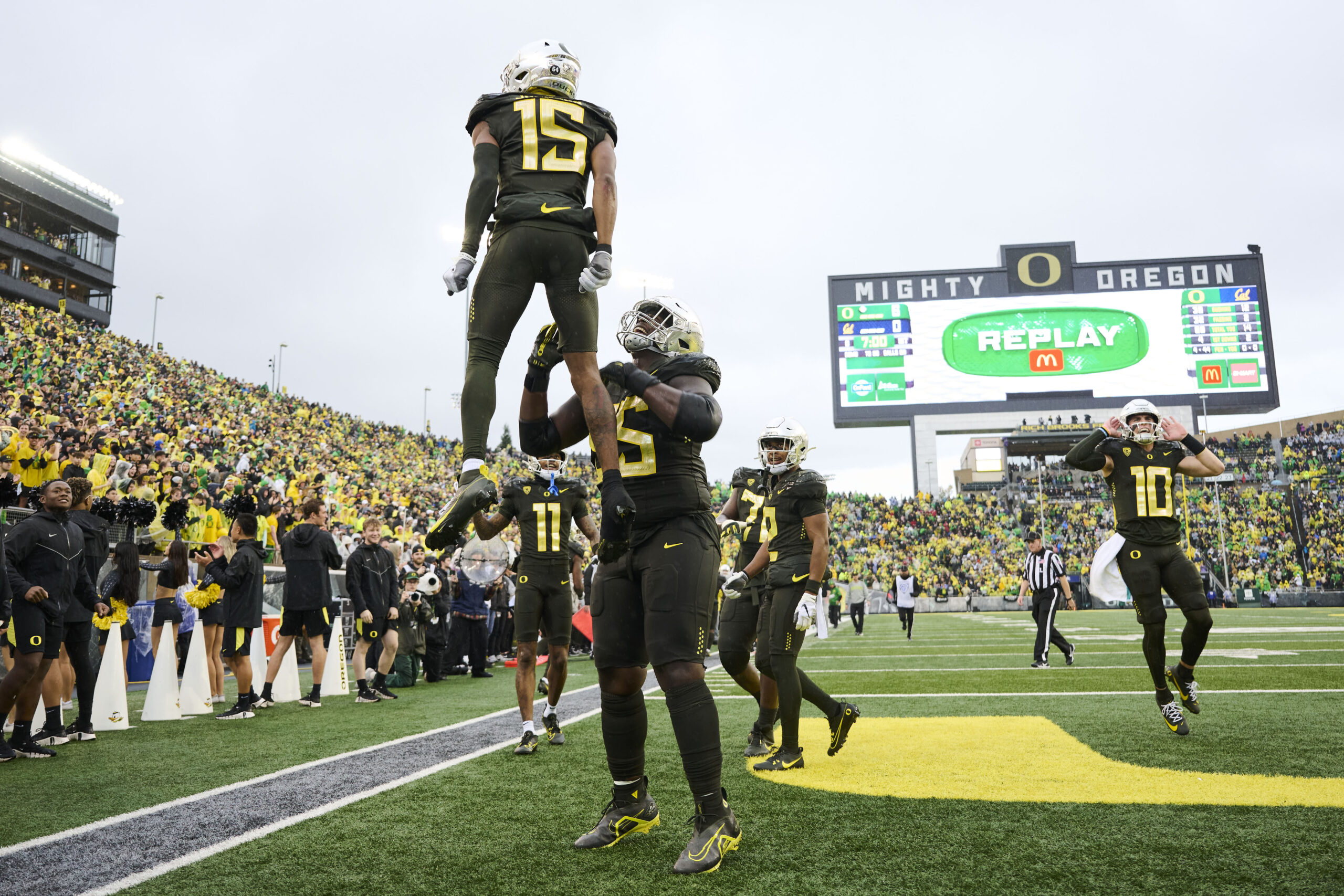 Nov 4, 2023; Eugene, Oregon, USA; Oregon Ducks offensive lineman Marcus Harper II (55) lifts wide receiver Tez Johnson (15) into the air after a touchdown during the first half against the California Golden Bears at Autzen Stadium.
