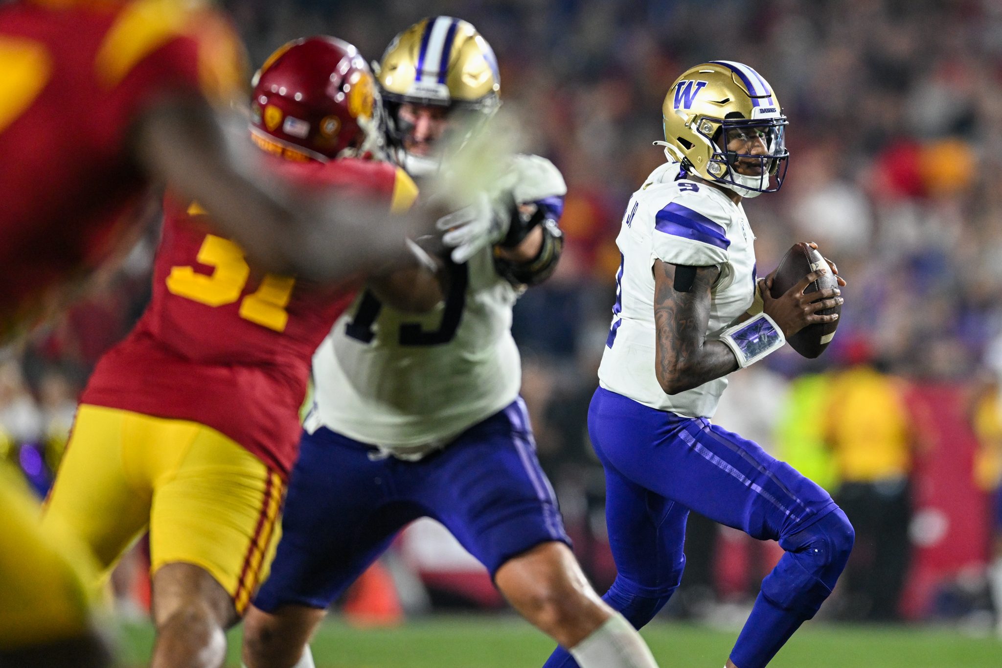 Washington Huskies quarterback Michael Penix Jr. (9) looks to pass against the USC Trojans.