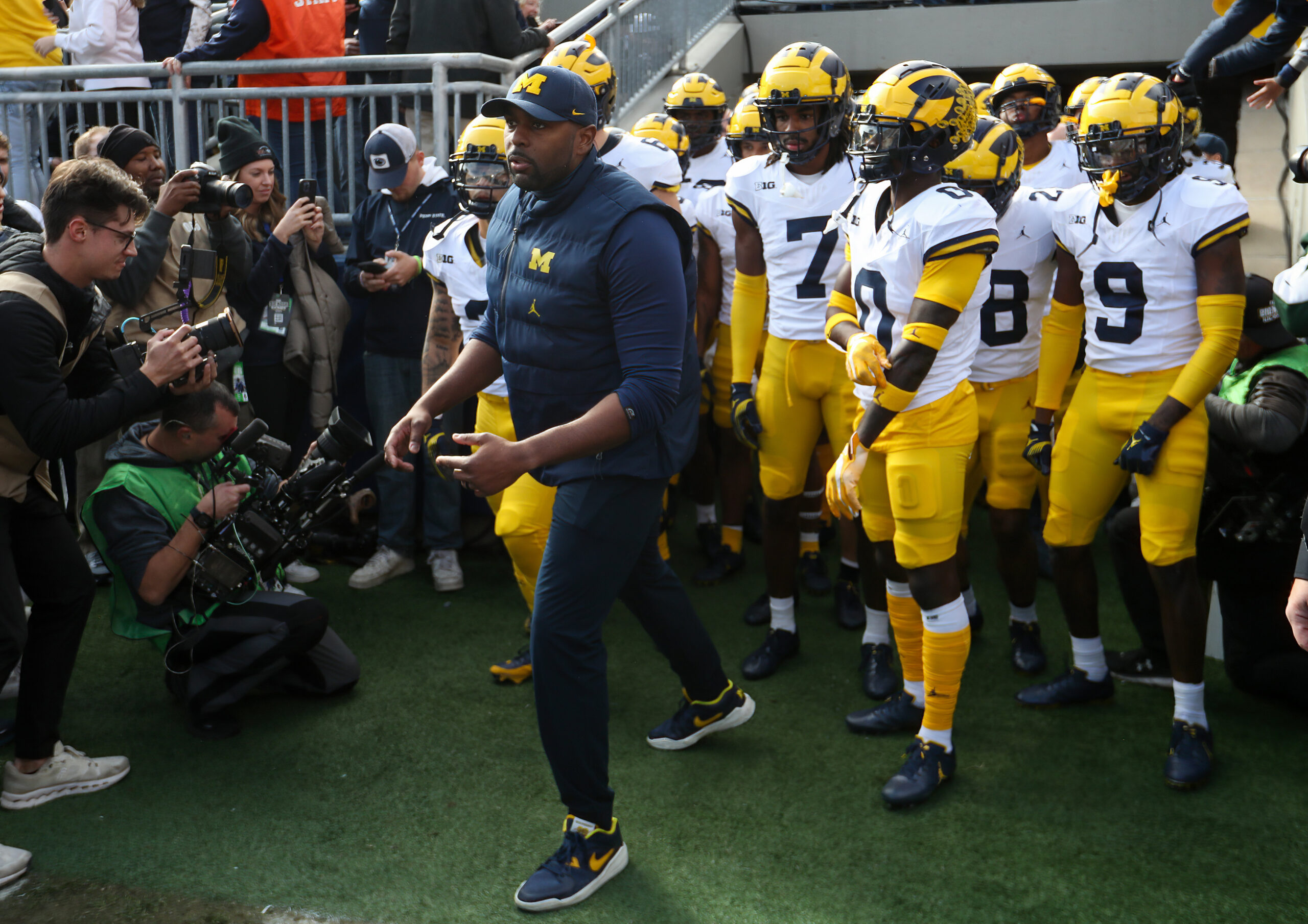 Nov 11, 2023; University Park, Pennsylvania, USA; Michigan Wolverines offensive lines coach Sherrone Moore leads the team onto the field before a game against the Penn State Nittany Lions at Beaver Stadium.