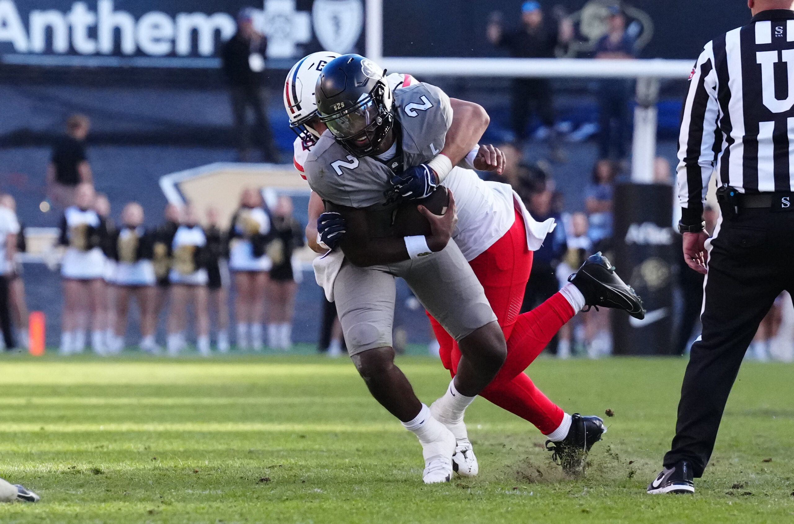 Nov 11, 2023; Boulder, Colorado, USA; Arizona Wildcats linebacker Dominic Lolesio (42) tackles Colorado Buffaloes quarterback Shedeur Sanders (2) in the second half at Folsom Field. 