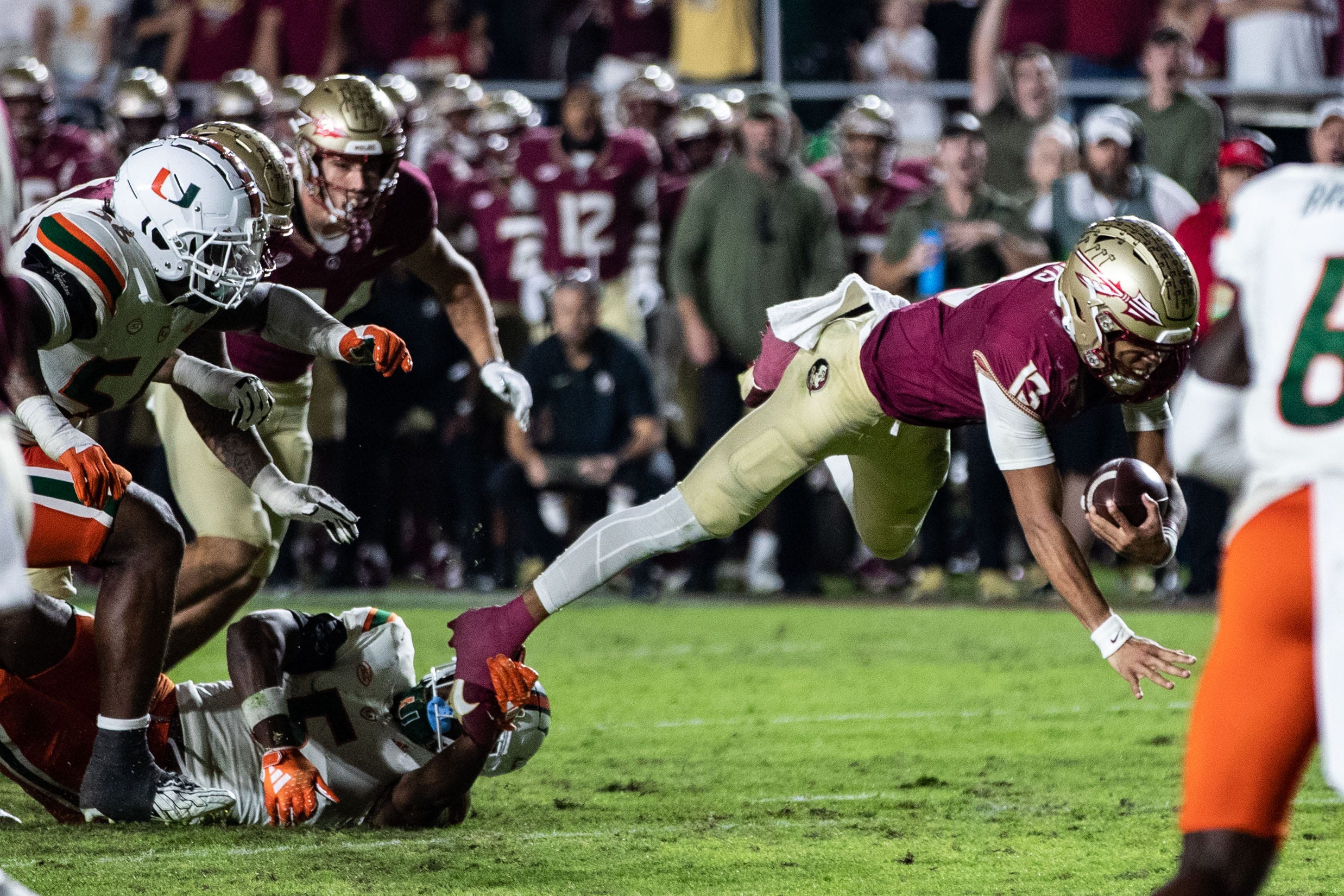 Florida State Seminoles quarterback Jordan Travis (13) dives forward towards the end zone. The Florida State Seminoles defeated the Miami Hurricanes 27-20 on Saturday, Nov. 11, 2023.