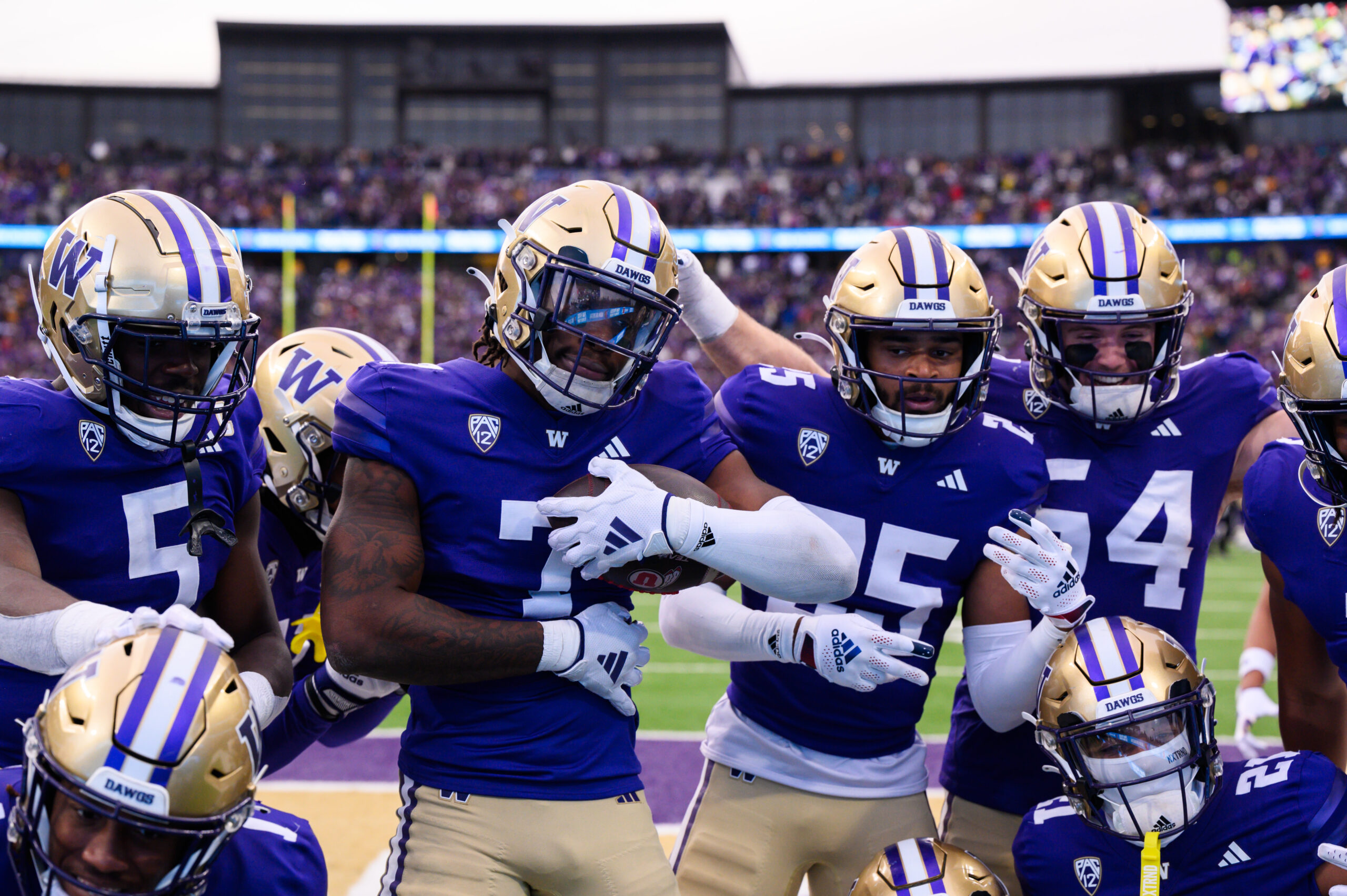 Nov 11, 2023; Seattle, Washington, USA; The Washington Huskies celebrate after a fourth down defensive stop against the Utah Utes during the second half at Alaska Airlines Field at Husky Stadium.