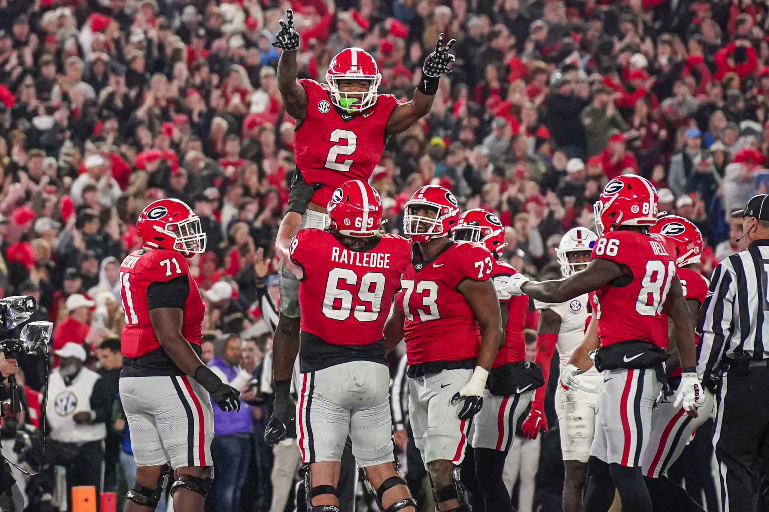 Nov 11, 2023; Athens, Georgia, USA; Georgia Bulldogs running back Kendall Milton (2) reacts with offensive lineman Tate Ratledge (69) after scoring a touchdown against the Mississippi Rebels during the first half at Sanford Stadium. Mandatory Credit: Dale Zanine-USA TODAY Sports